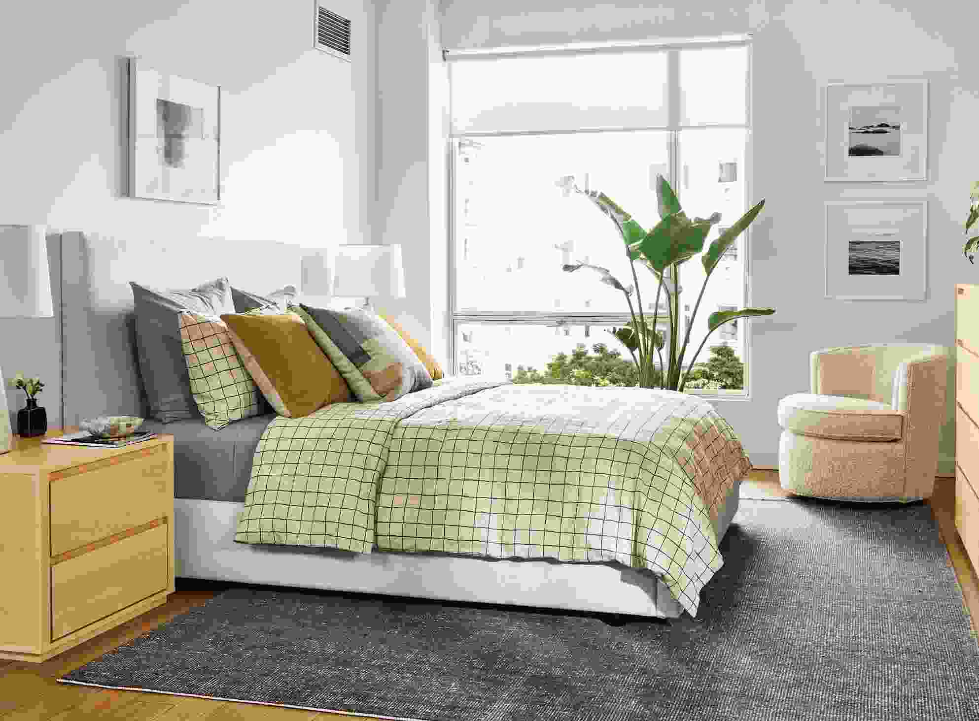 Bedroom with Wyatt queen bed in Sumner Ivory and Arro nightstand and ten-drawer dresser in maple.