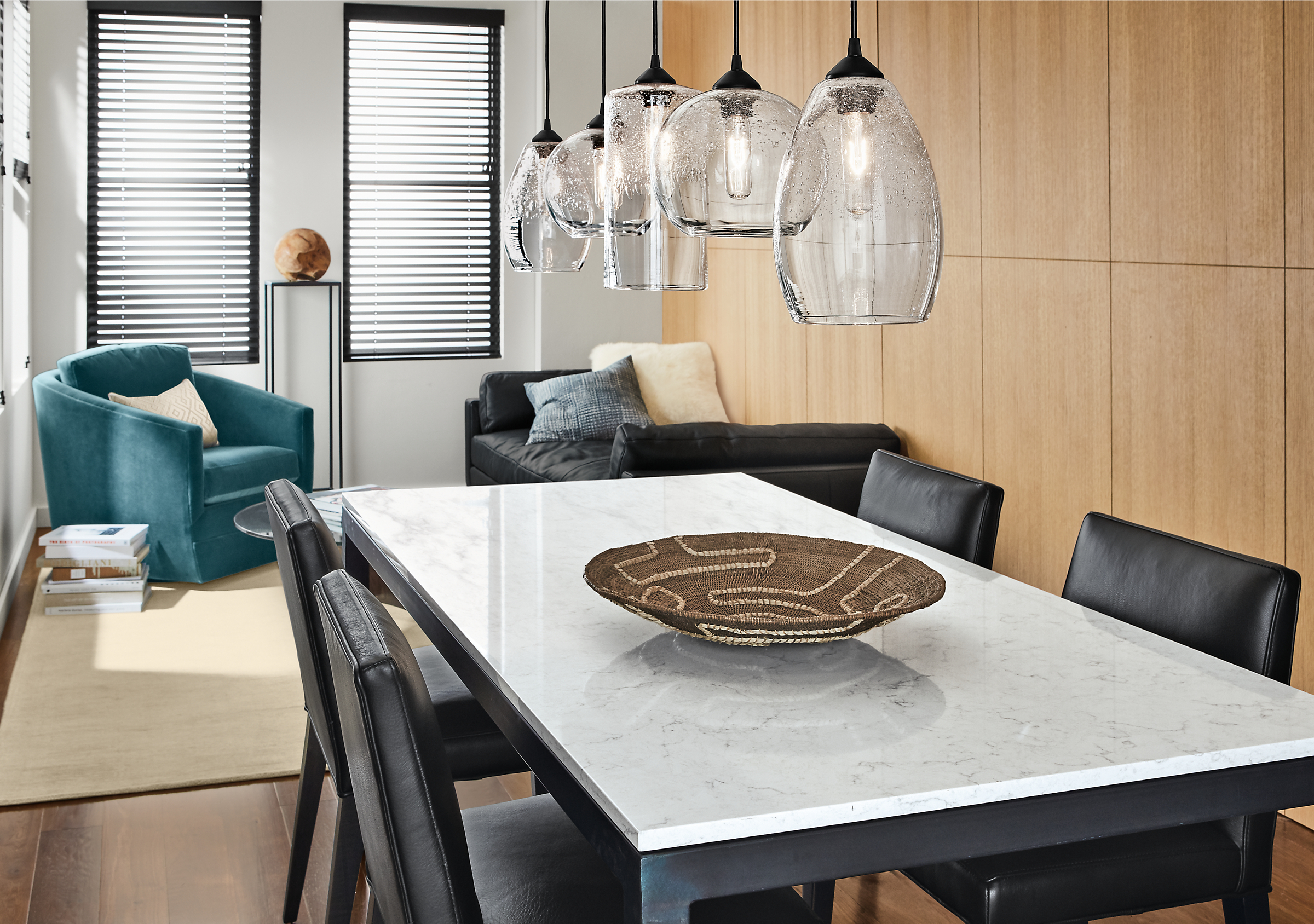 Detail of five Abra glass pendants above a Parsons 72-wide   table with a Marbled White Quartz top.