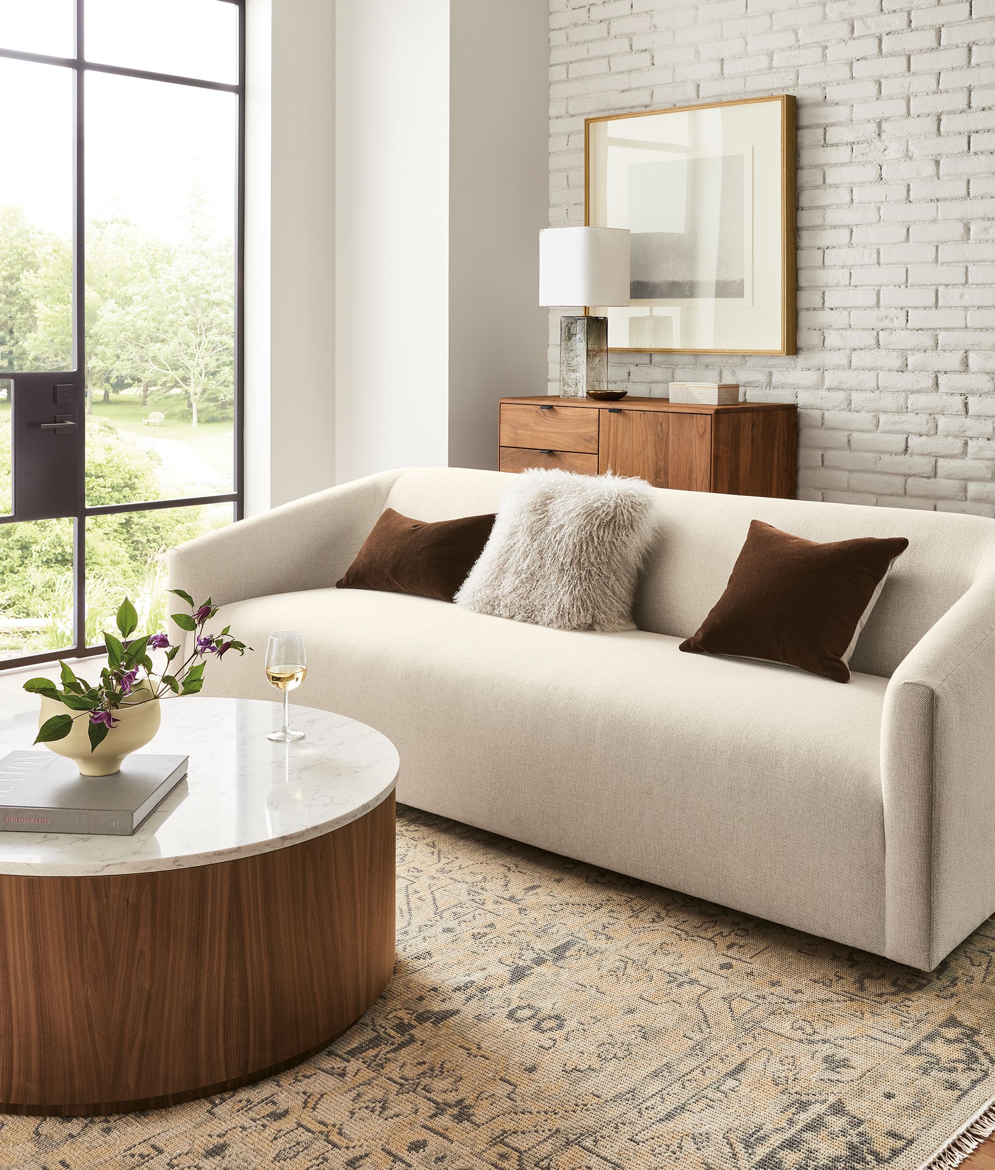 Living room with Ada 90-wide sofa in Tepic Ivory. Liam 36-diameter round coffee table with marbled white quartz top.