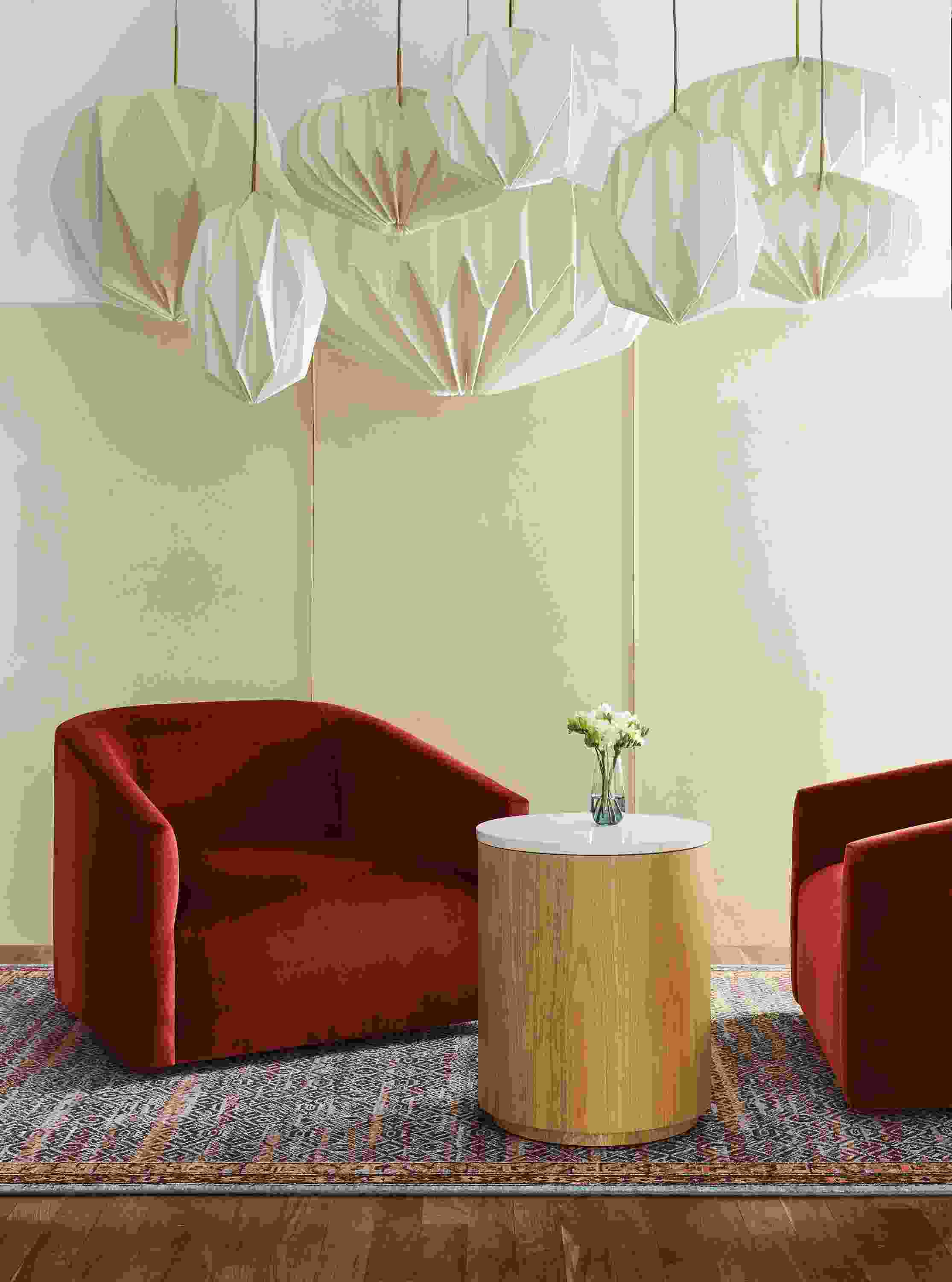 Living room with Ada chairs in Vance Paprika and various Orikata pendant lights.