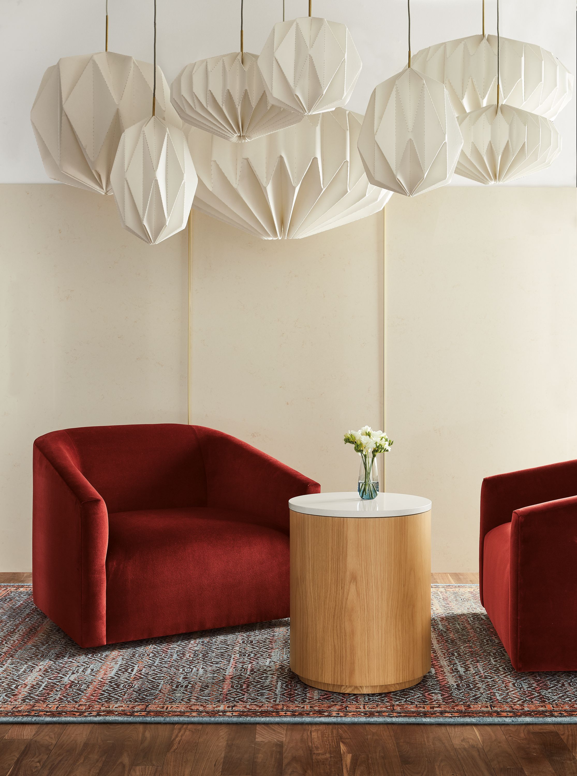 Living room with Ada chairs in Vance Paprika and various Orikata pendant lights.