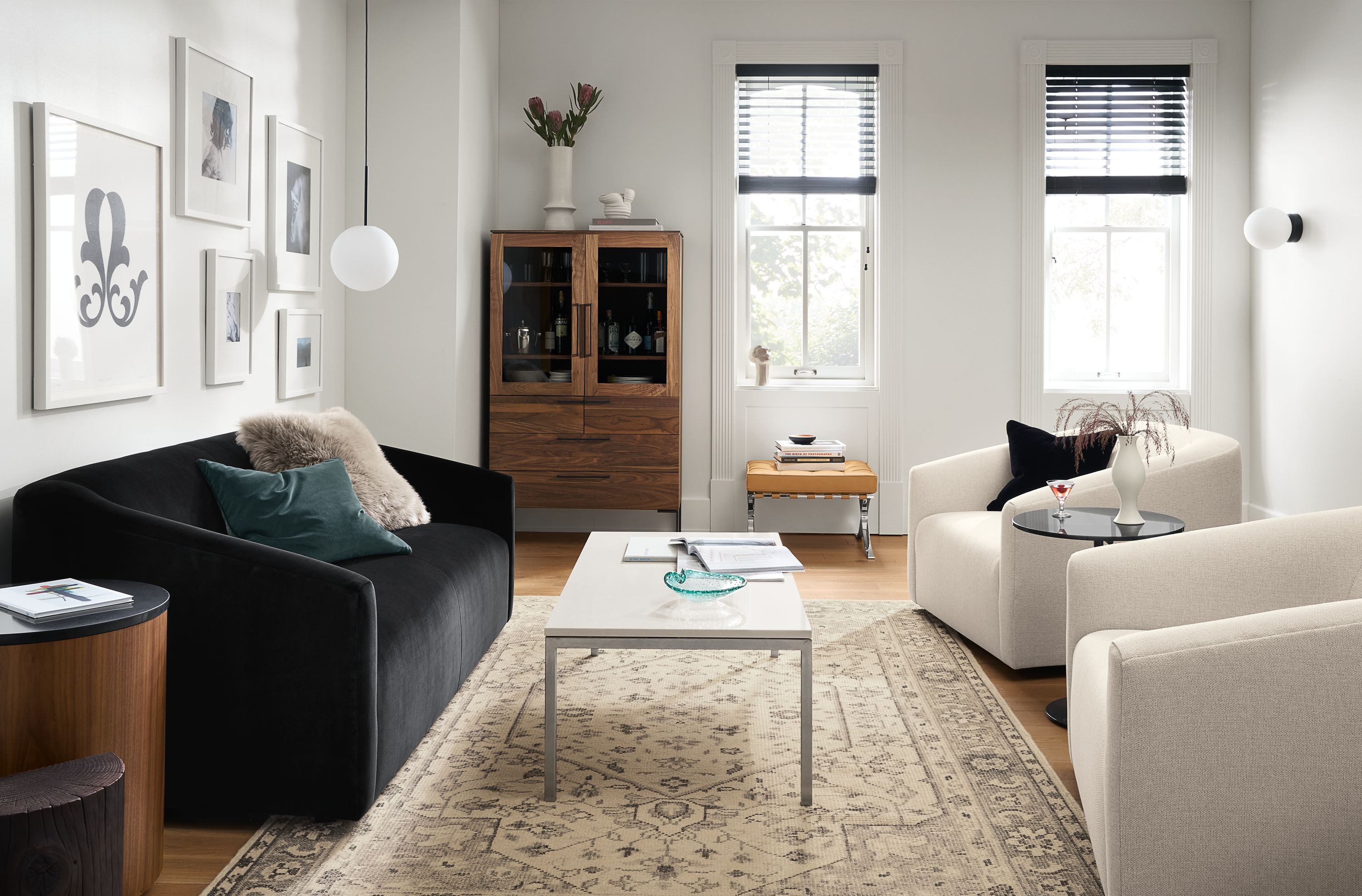 Living room with Ada 70-wide sofa in Vance Ebony fabric, Ada swivel chair in Tepic Ivory, and Portica Coffee table.