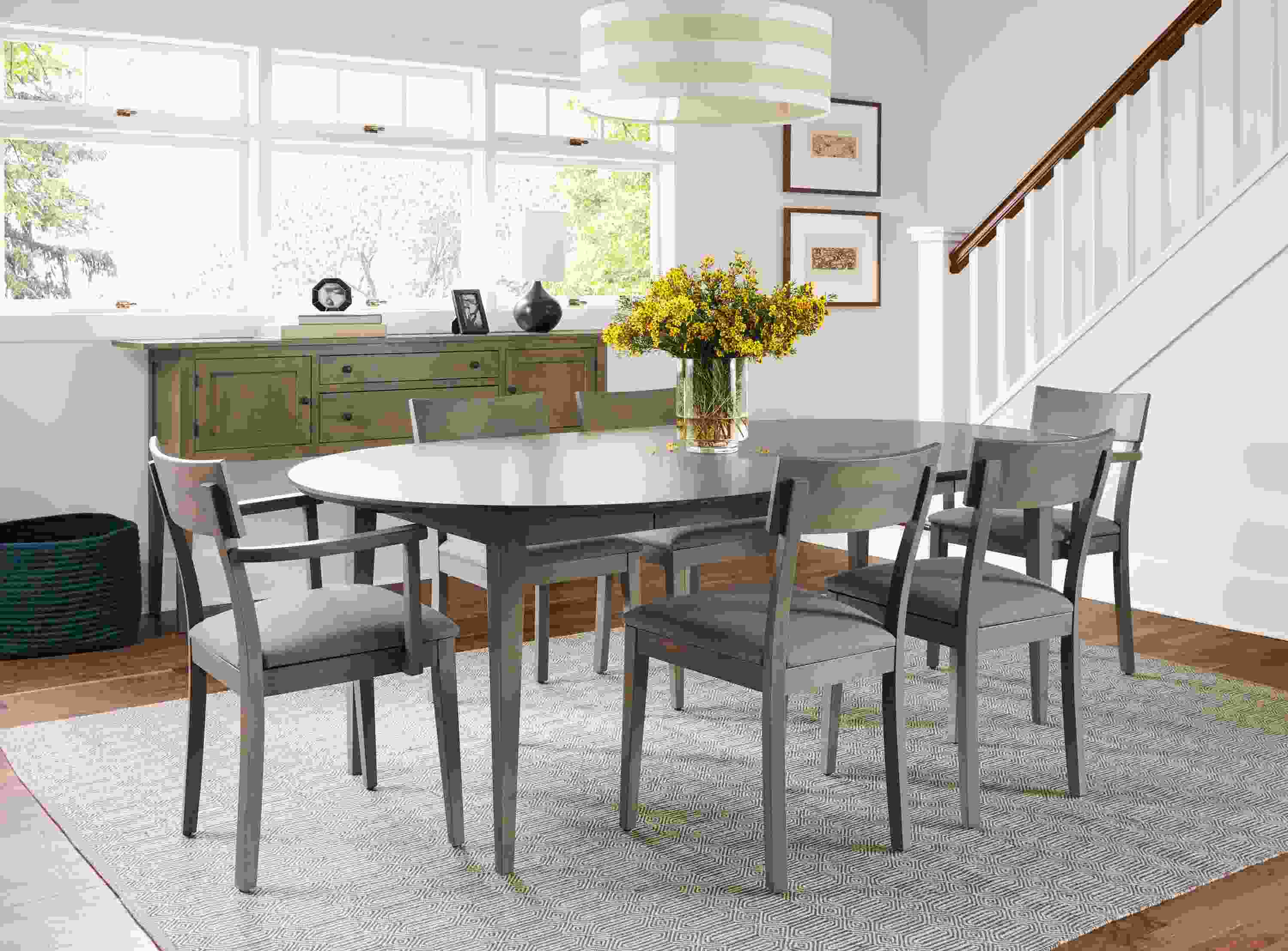 Dining room with Adams extension table in shell finish with Doyle arm and side chairs with Canvas Slate seat fabric and shell finish.