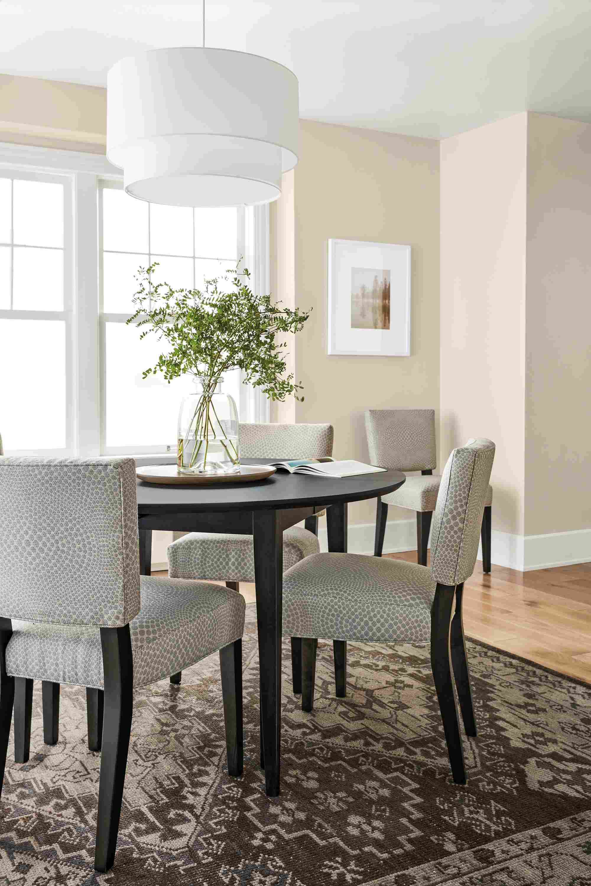 Dining room with Adams extension table in charcoal and 5 Georgia side chairs in charcoal with mirror cement upholstery.