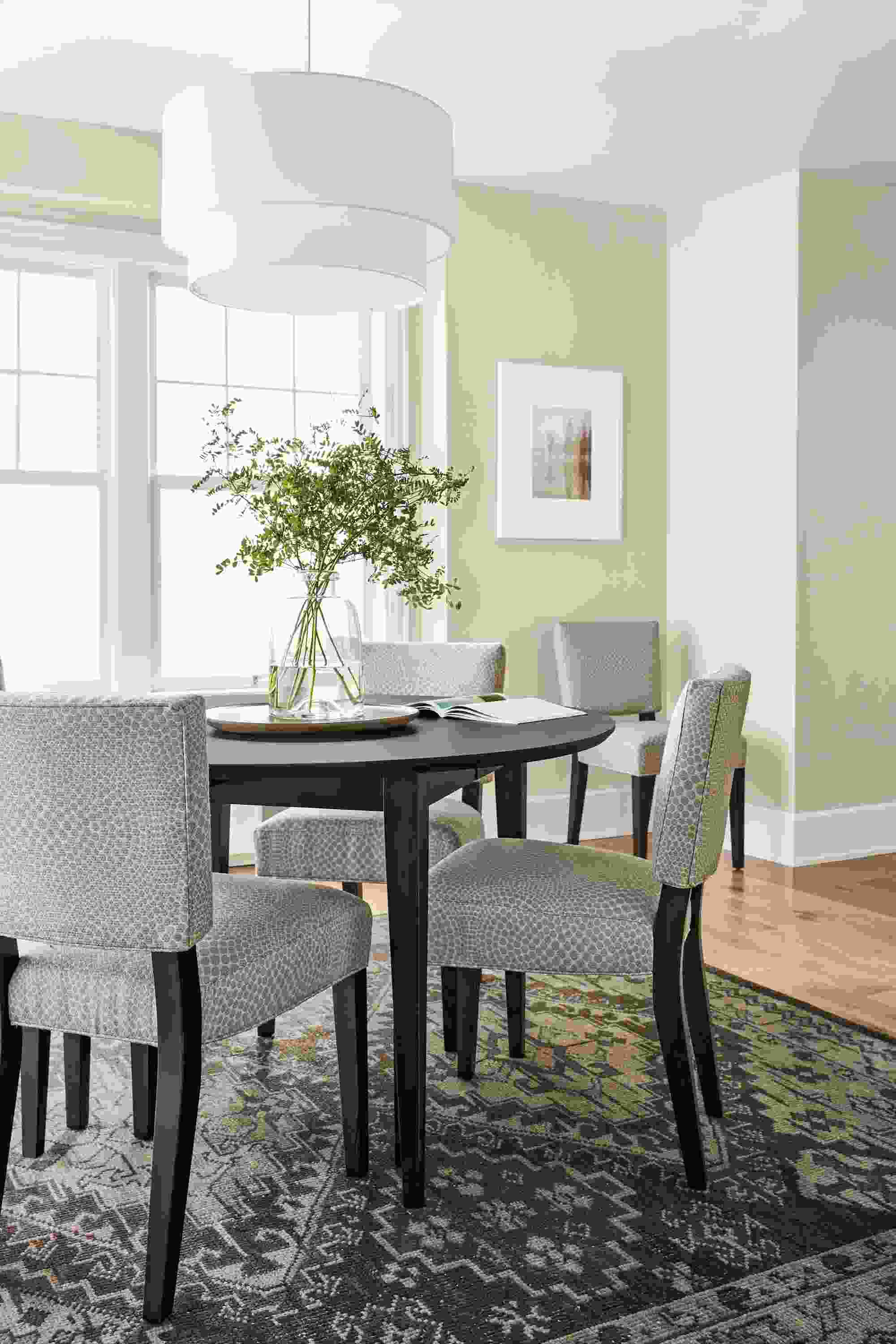 Dining room with Adams extension table in charcoal and 5 Georgia side chairs in charcoal with mirror cement upholstery.