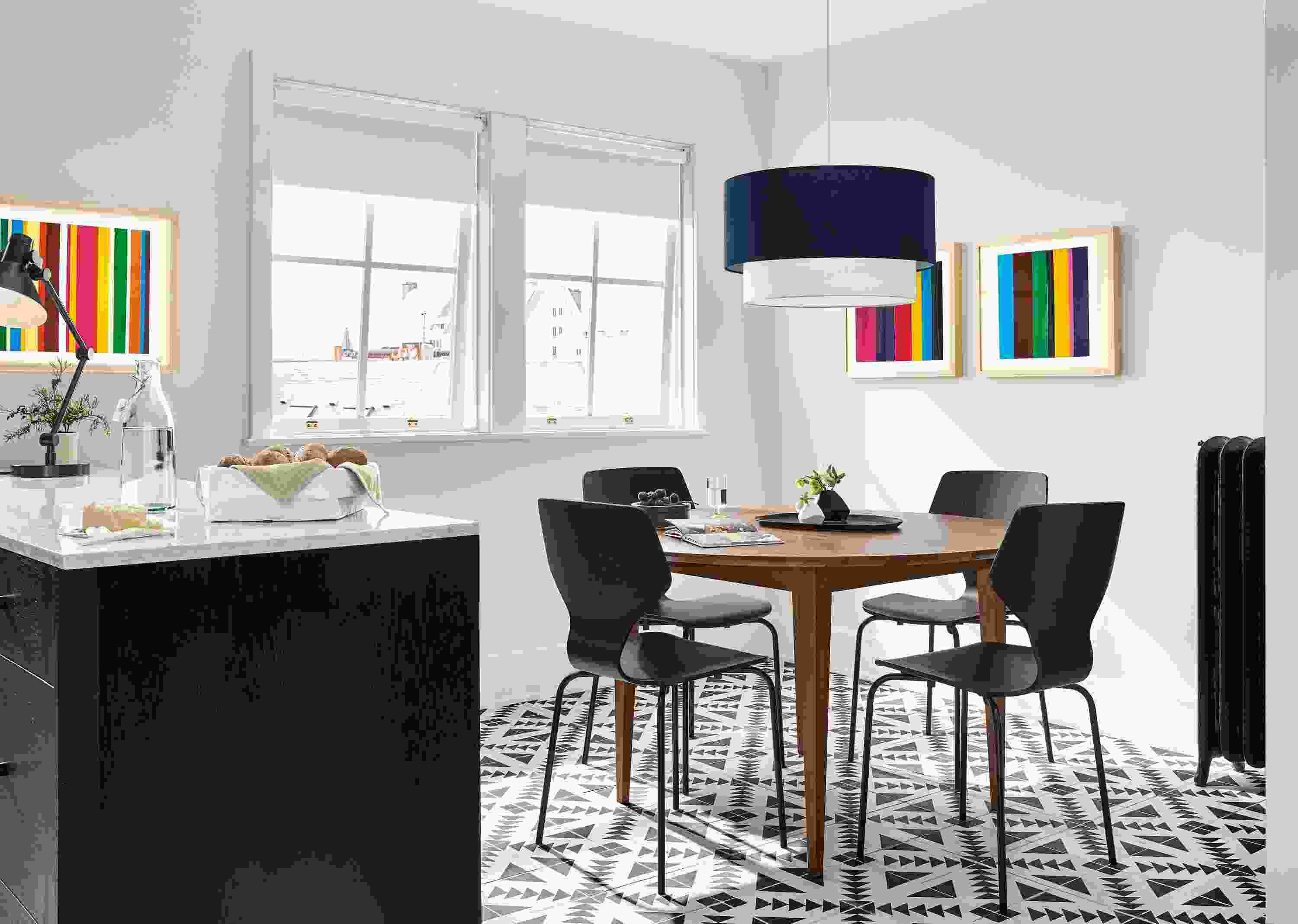 Bright kitchen with Adams 48-diameter extension table in walnut and 4 Pike side chairs in black with graphite.