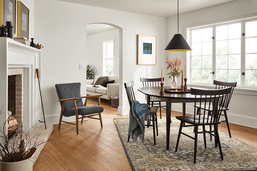 Dining room with Adams 48-inch diameter round extension table in charcoal and Thatcher side chair in charcoal finish.