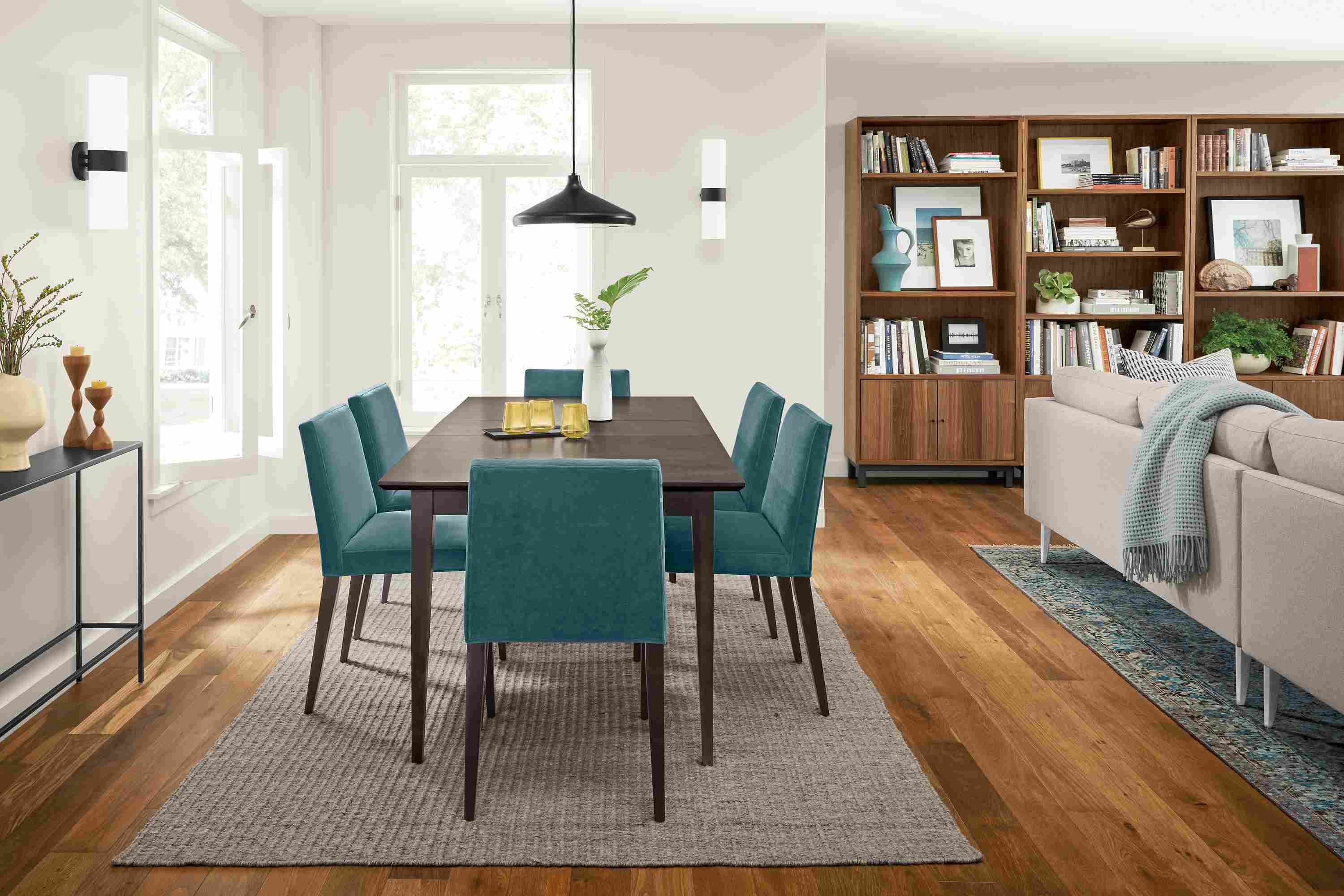 Home dining area with Adams 60-wide extension table in charcoal on maple and 6 Ava side chairs in Banks Lagoon.