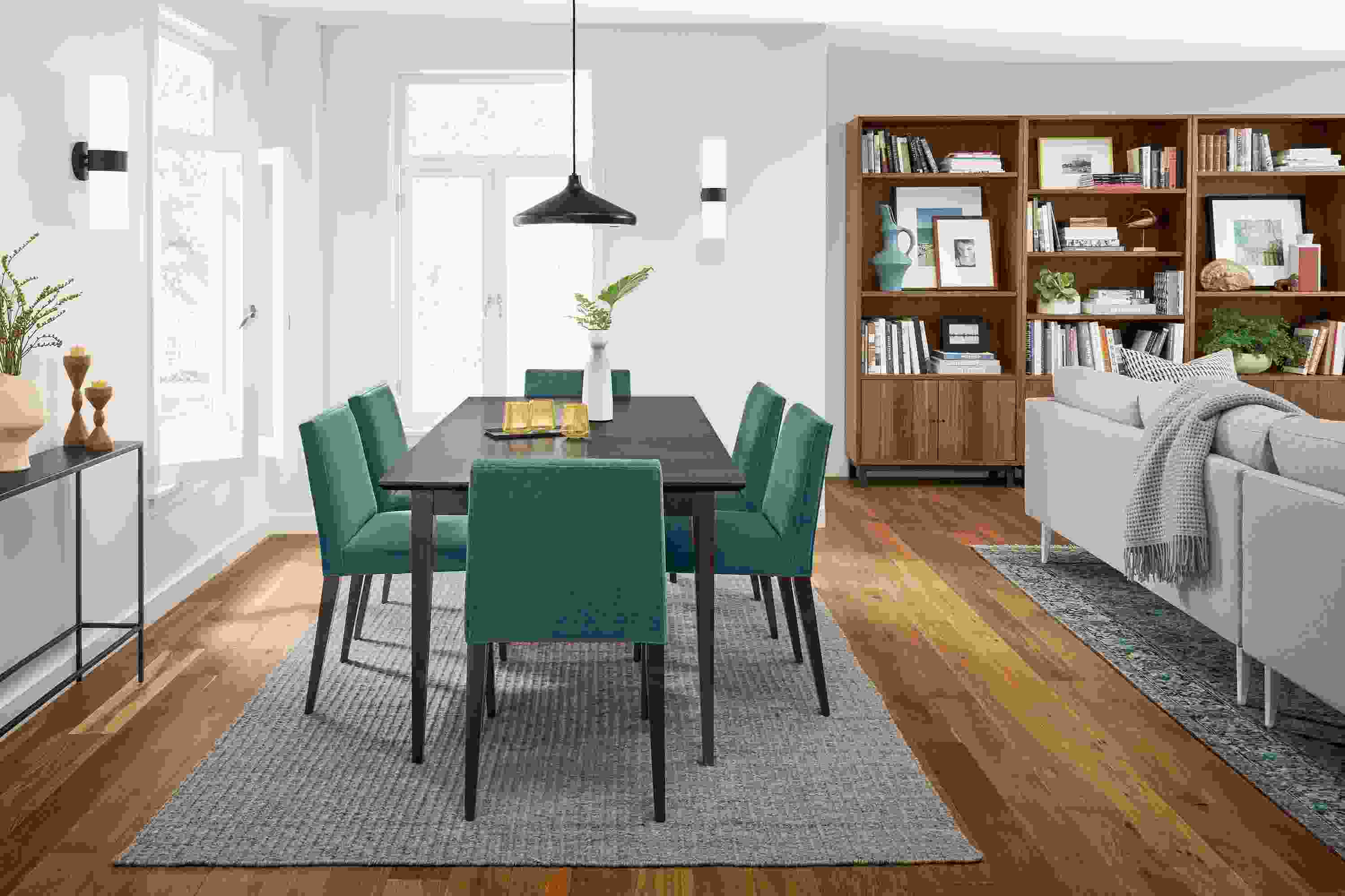 Home dining area with Adams 60-wide extension table in charcoal on maple and 6 Ava side chairs in Banks Lagoon.