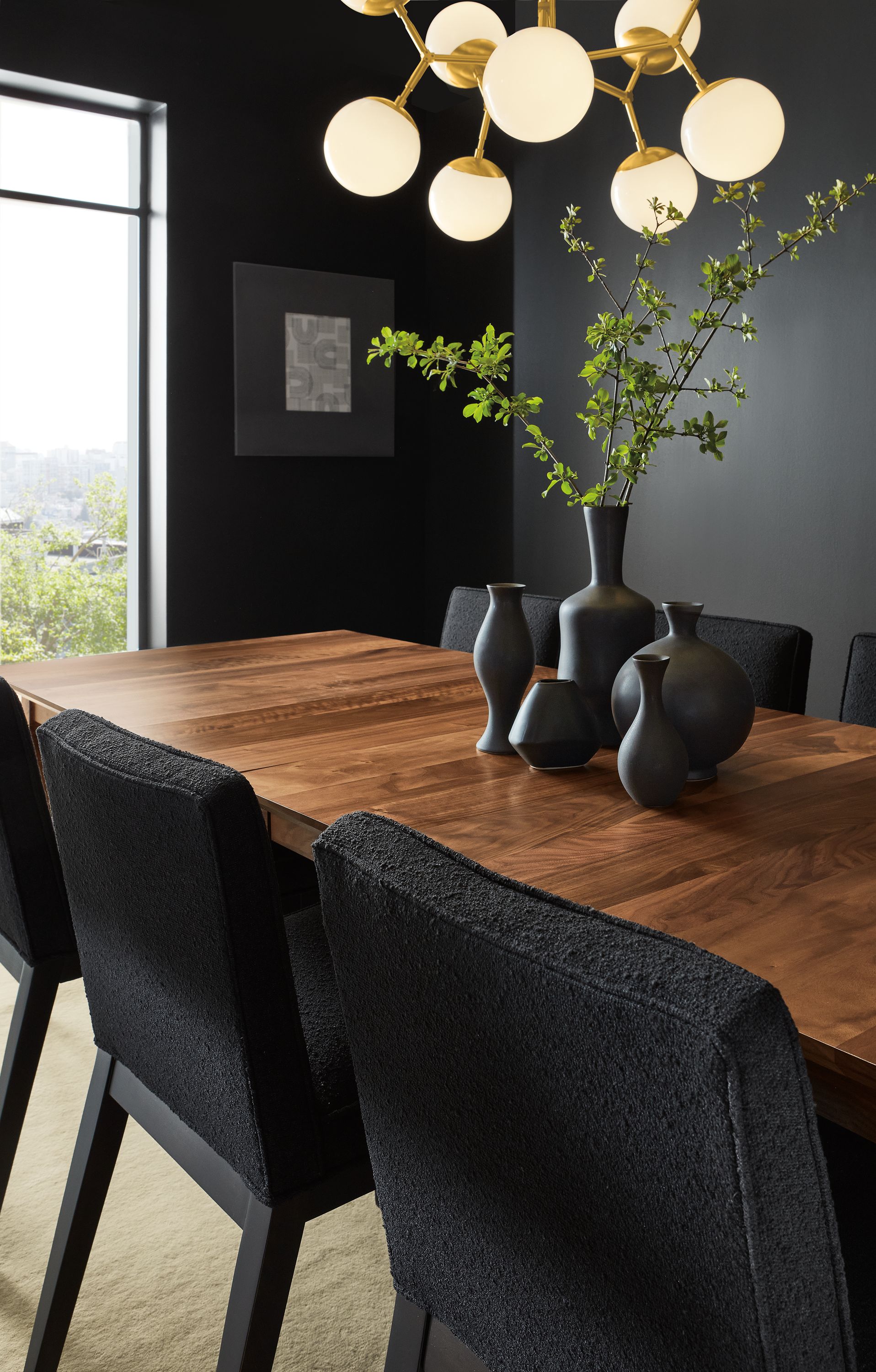Dining room with Adams extension table in walnut, Ansel side chairs in Declan Ebony and Cosma chandelier in brass.