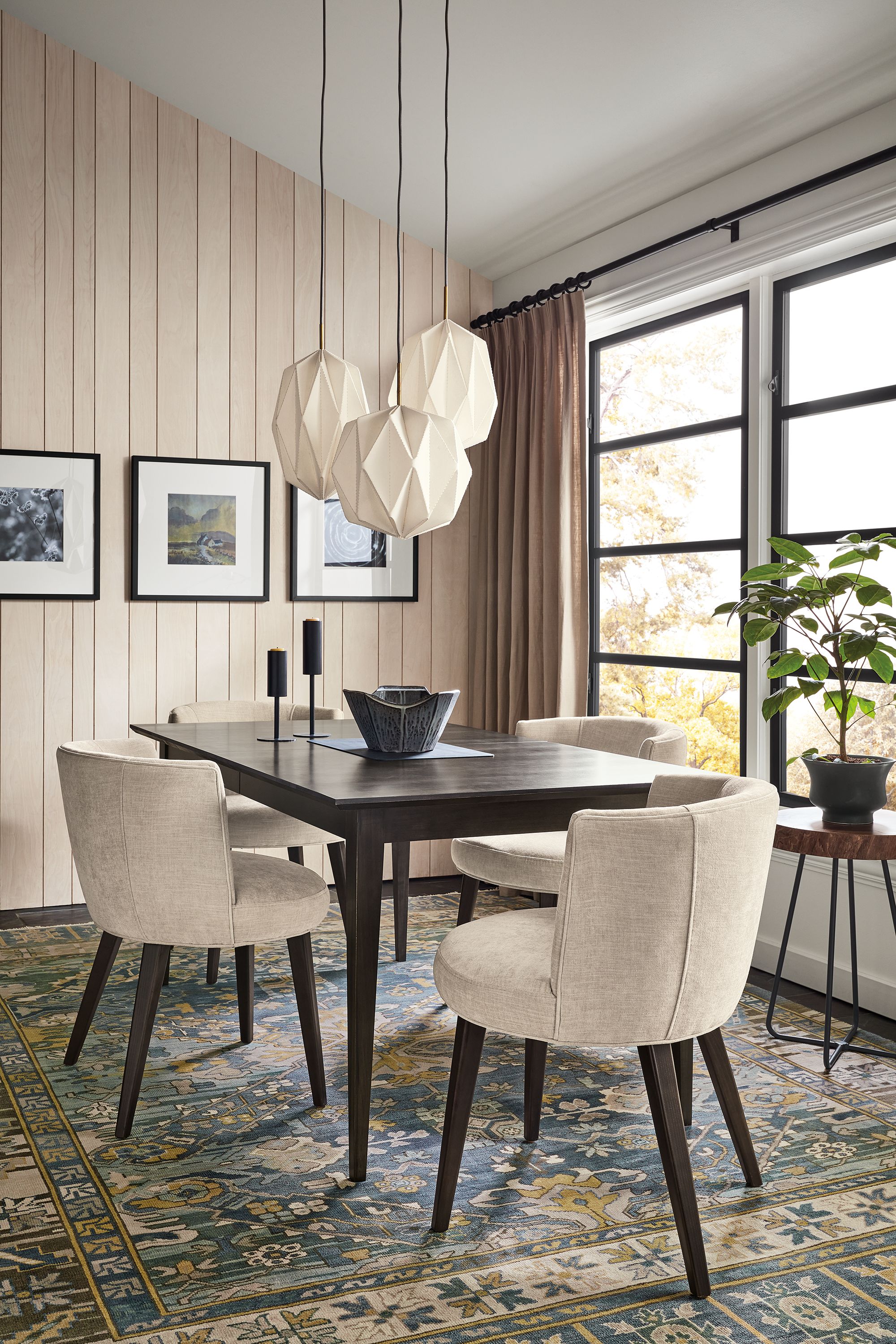 Dining room with Adams extension table in charcoal, June side chairs in Mori Oatmeal, Orikata pendants, marine Kayseri rug.
