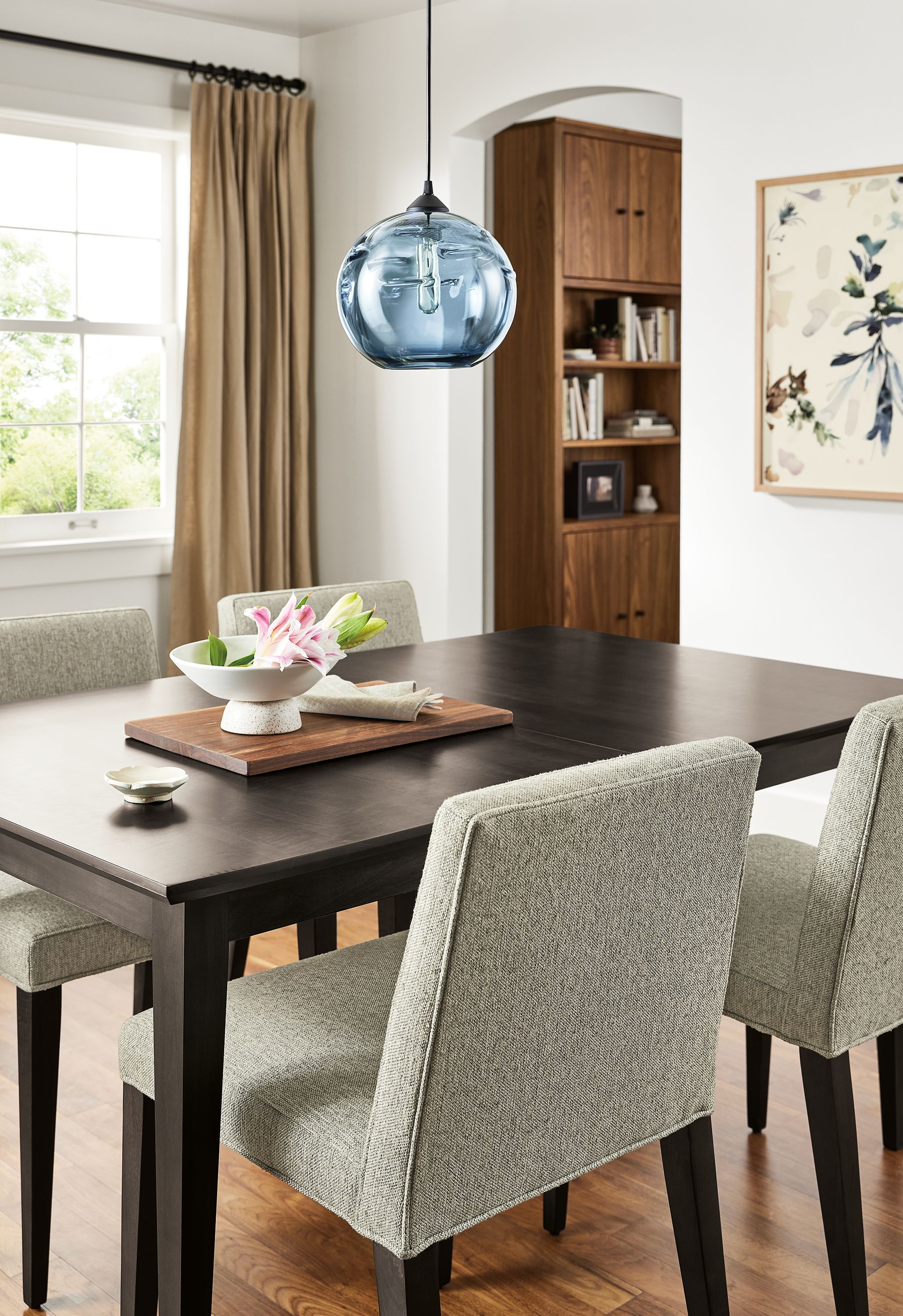 Dining room with Adams extension table in charcoal and 4 Ava side chairs in Conley Cloud.