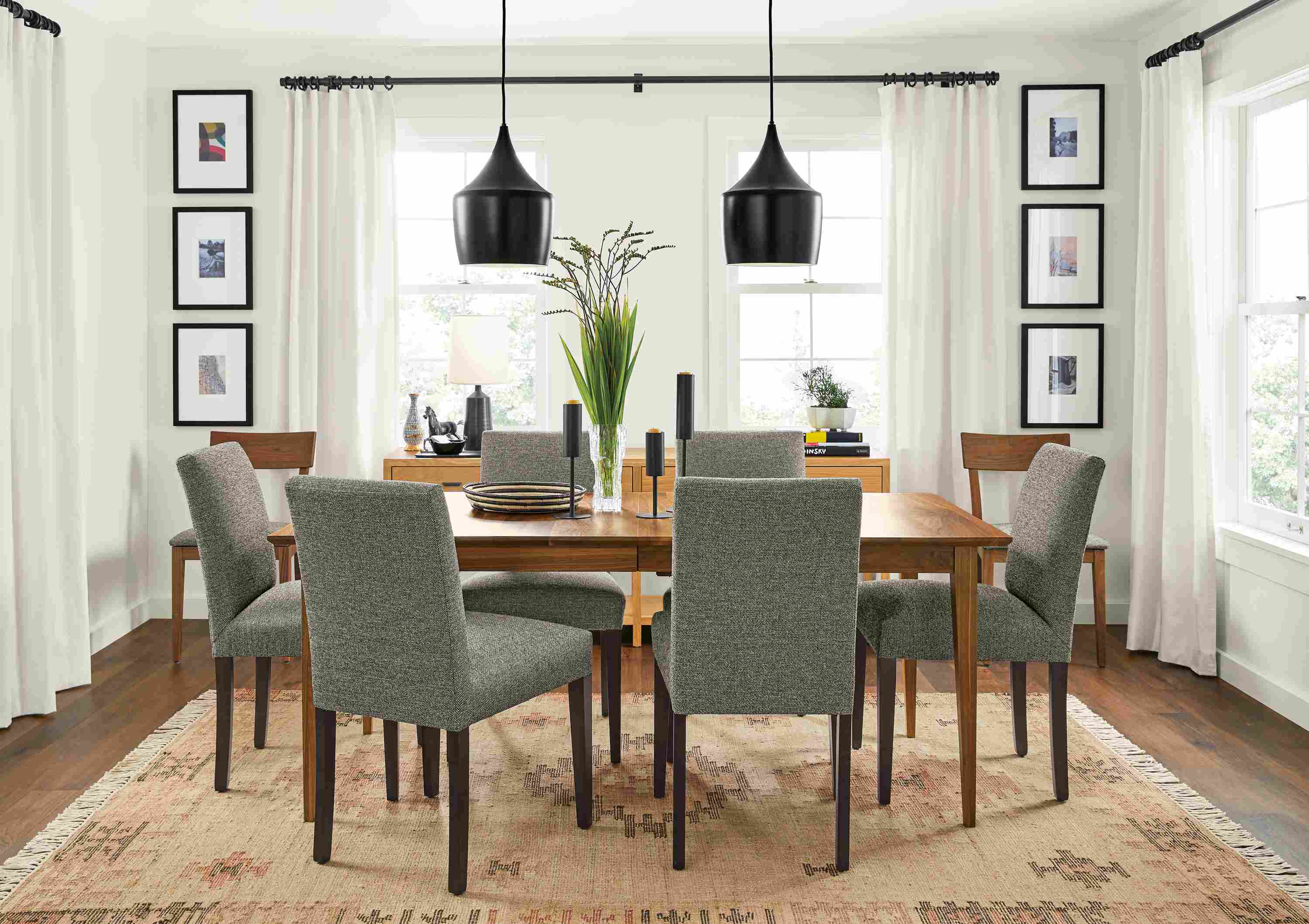 Detail of Adams extension table in walnut and Peyton chairs in Tatum Salt fabric in a dining room.