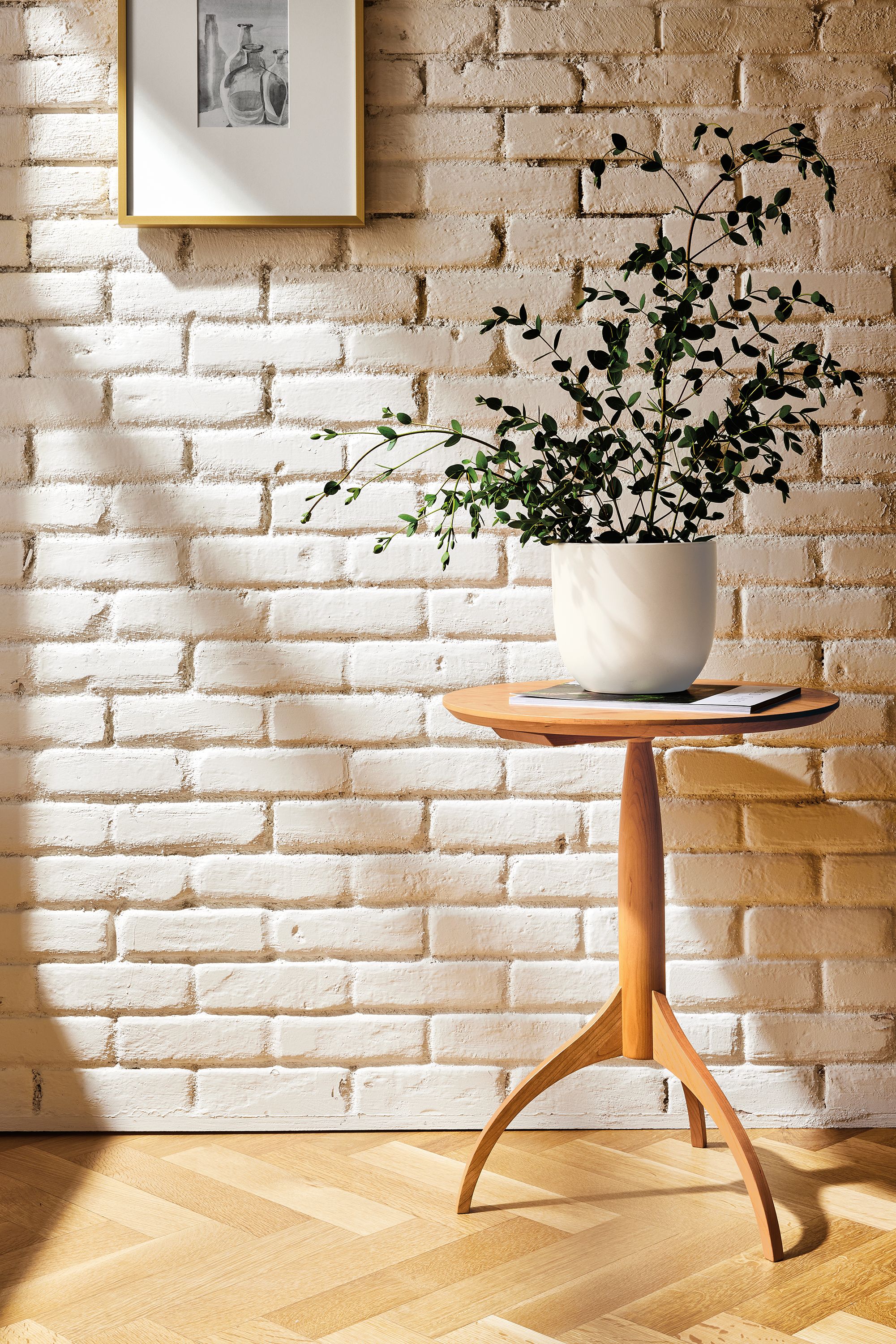 Entryway with Adams round end table in Cherry with houseplant on top.
