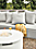 Detail of Adara round fire table in white on patio.