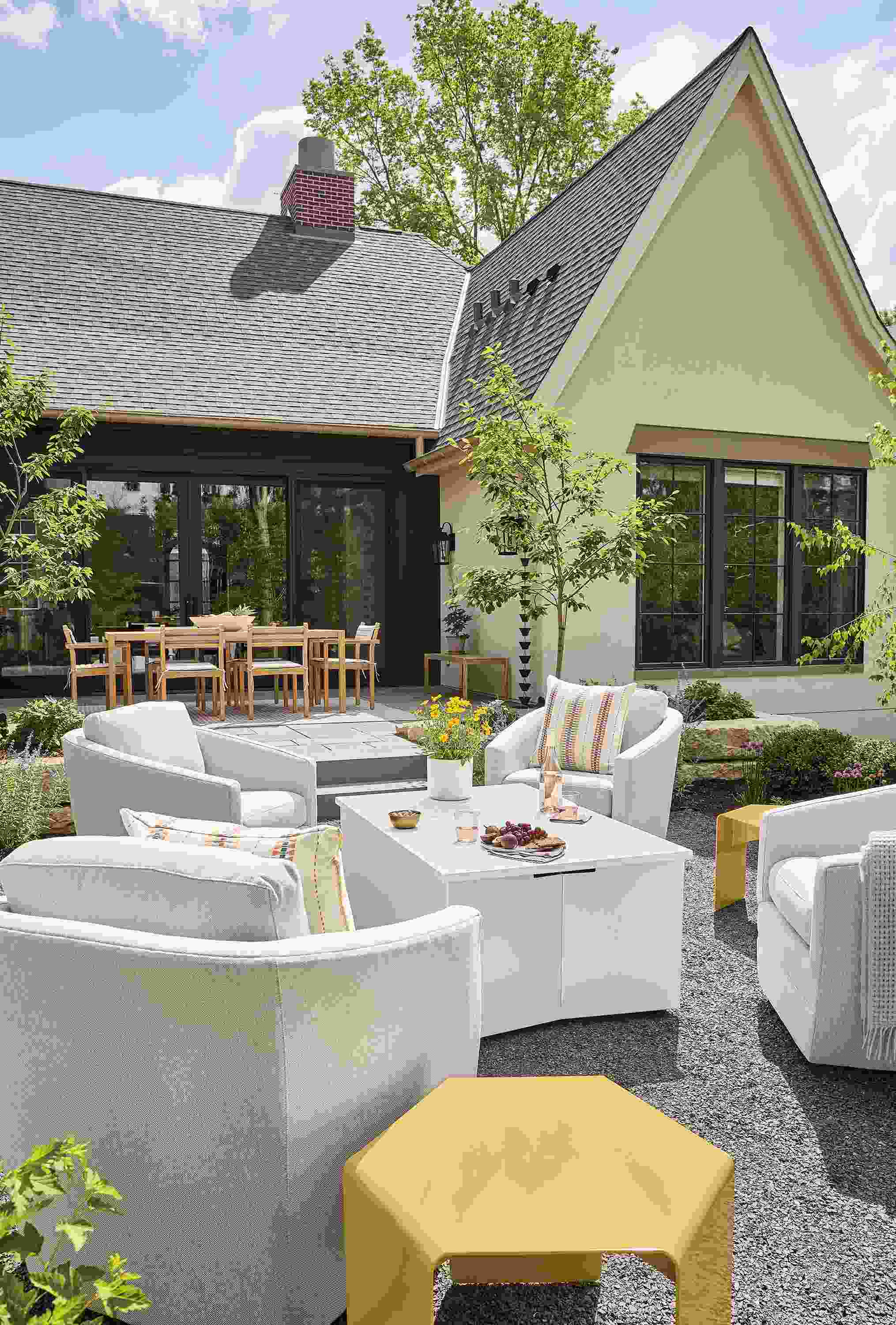Home outdoor seating area with Adara propane fire table in white and 4 Sunford swivel chairs in Mist Grey.