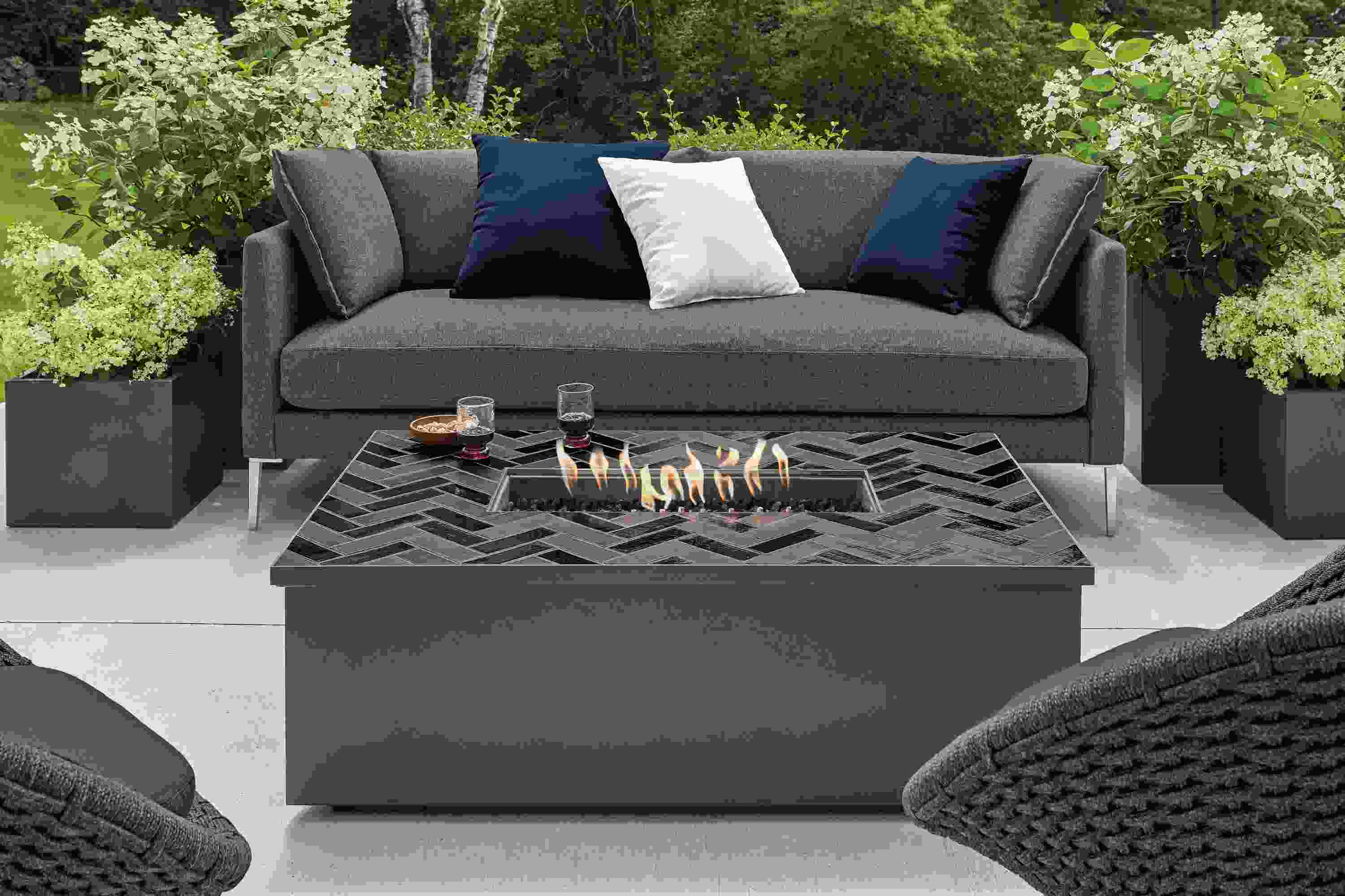 Patio with Adara outdoor fire table in graphite with tile top.