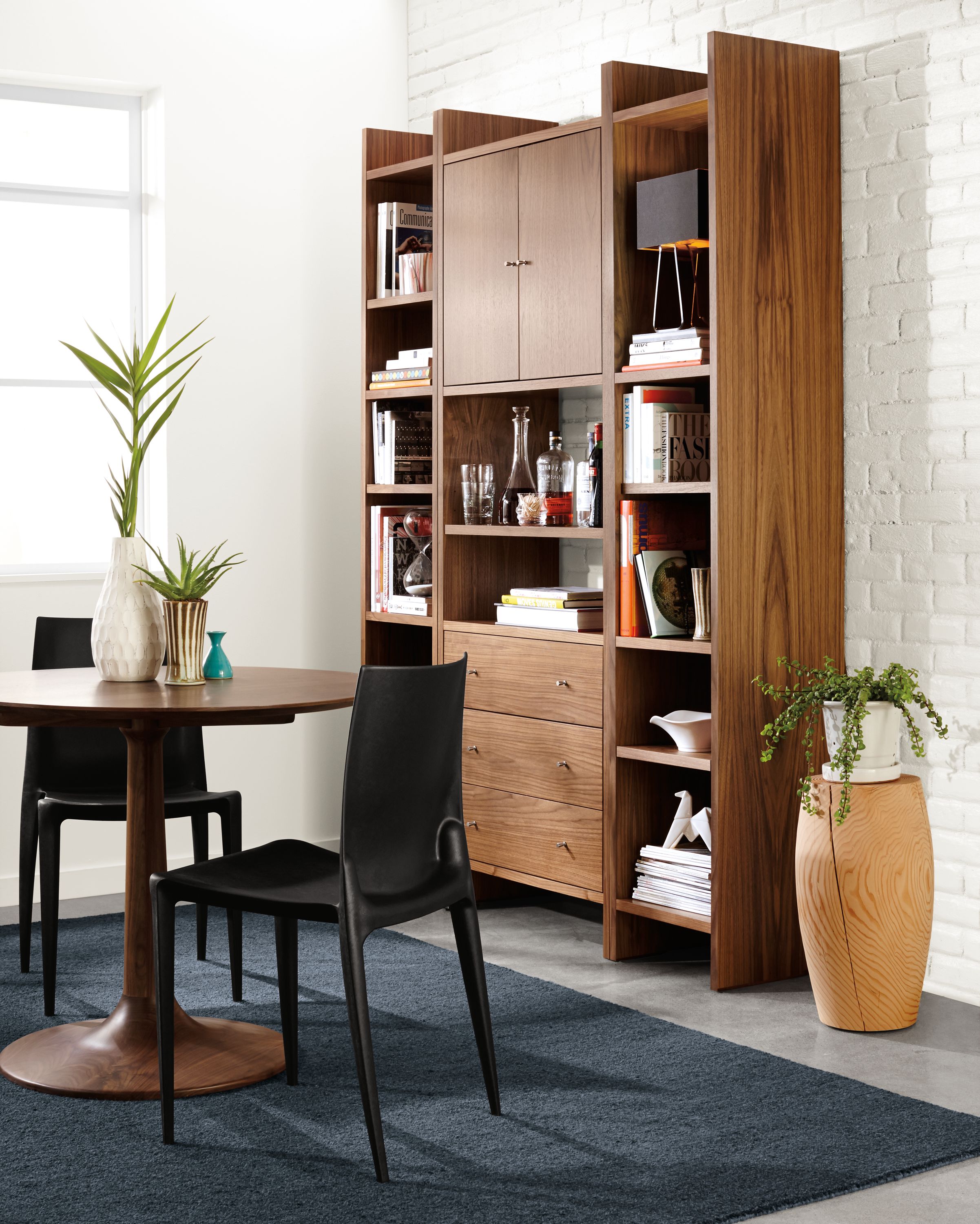 Dining room with Addison wall unit in walnut and Alder rug in Indigo.
