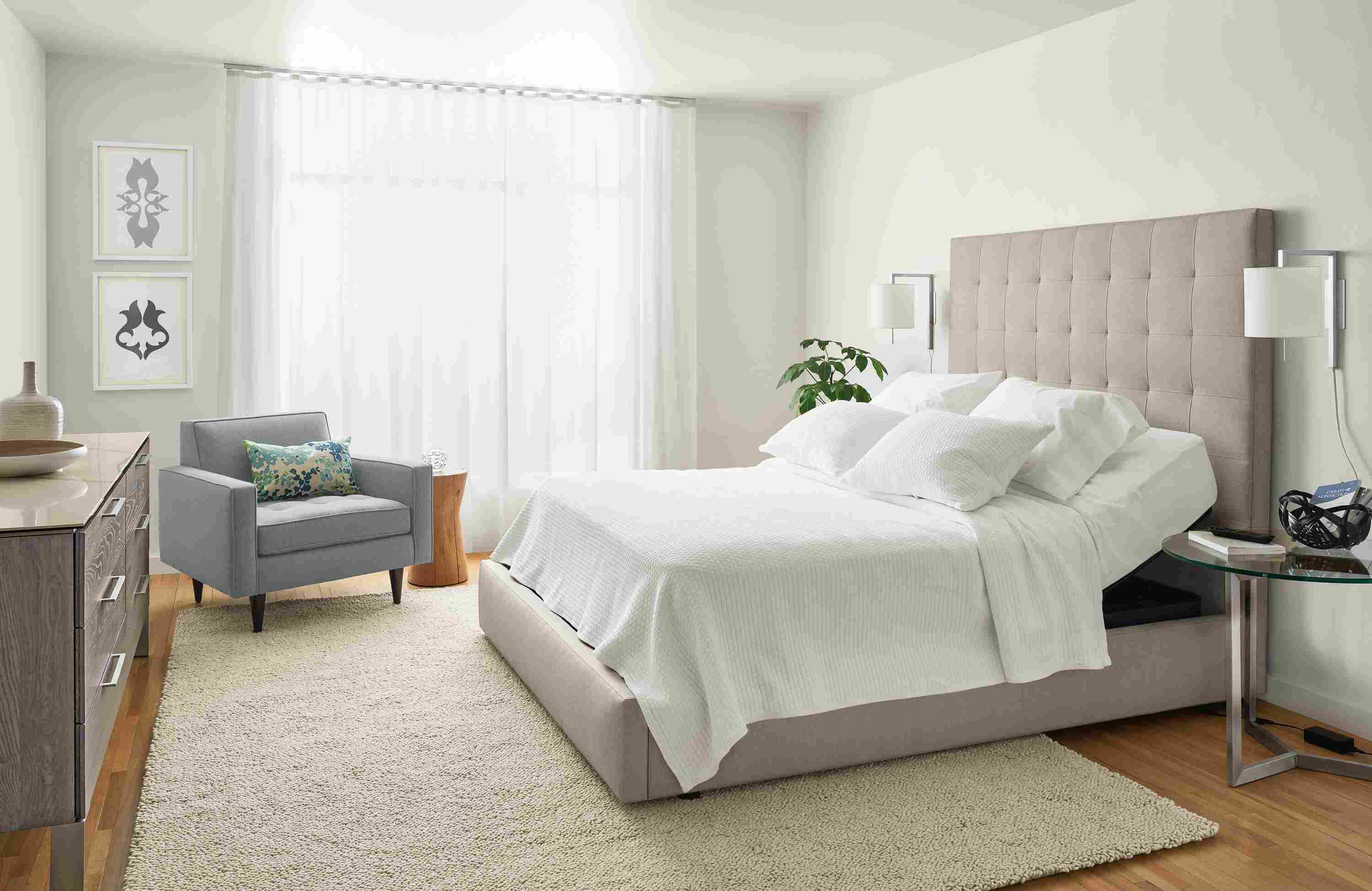 Bedroom with Room & Board adjustable mattress base shown slightly lifted near the headboard.