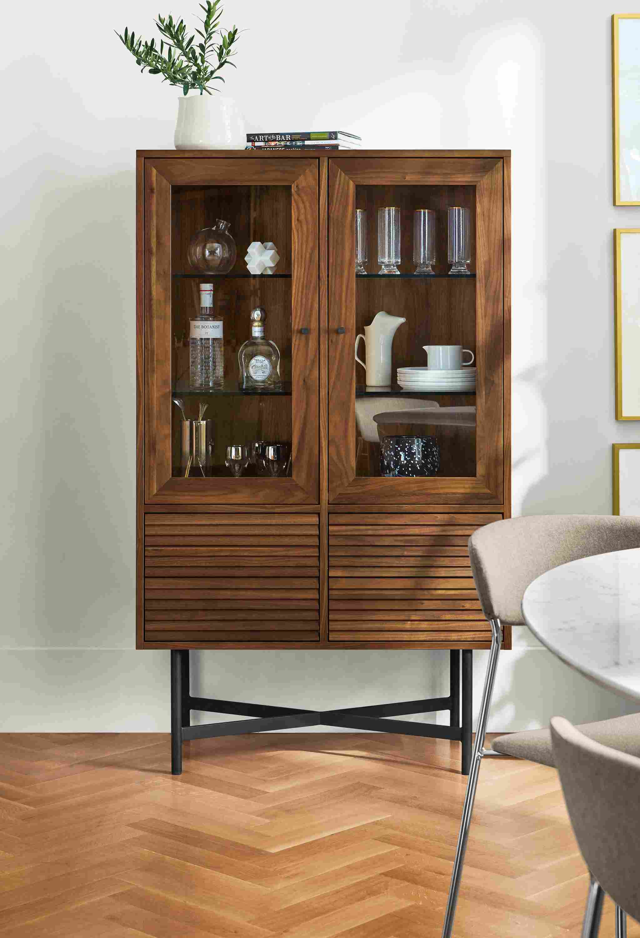 Dining room with detail of Adrian 36-wide storage cabinet in walnut and natural steel.