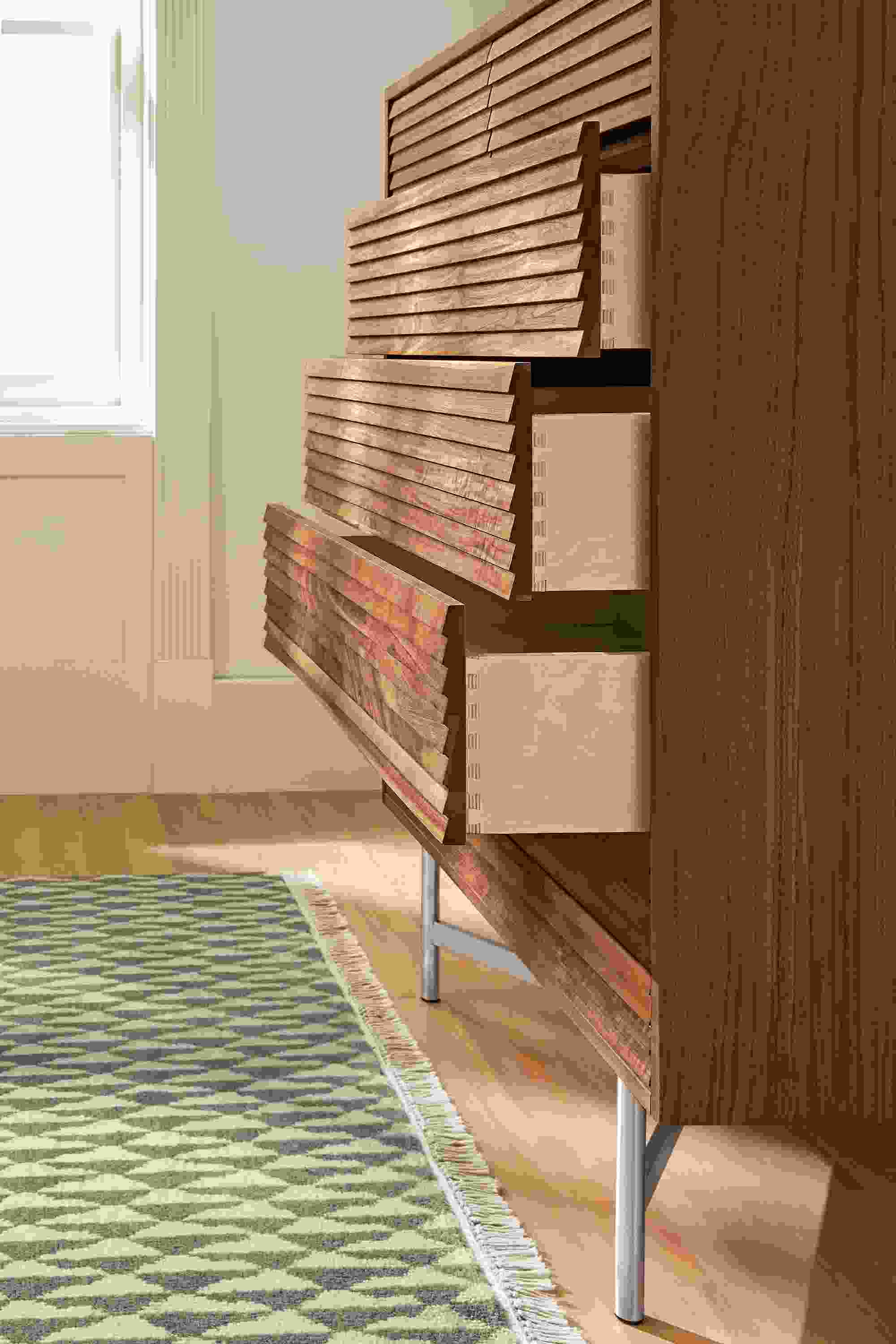 Side view of Adrian six-drawer dresser shown with drawers open different amounts.