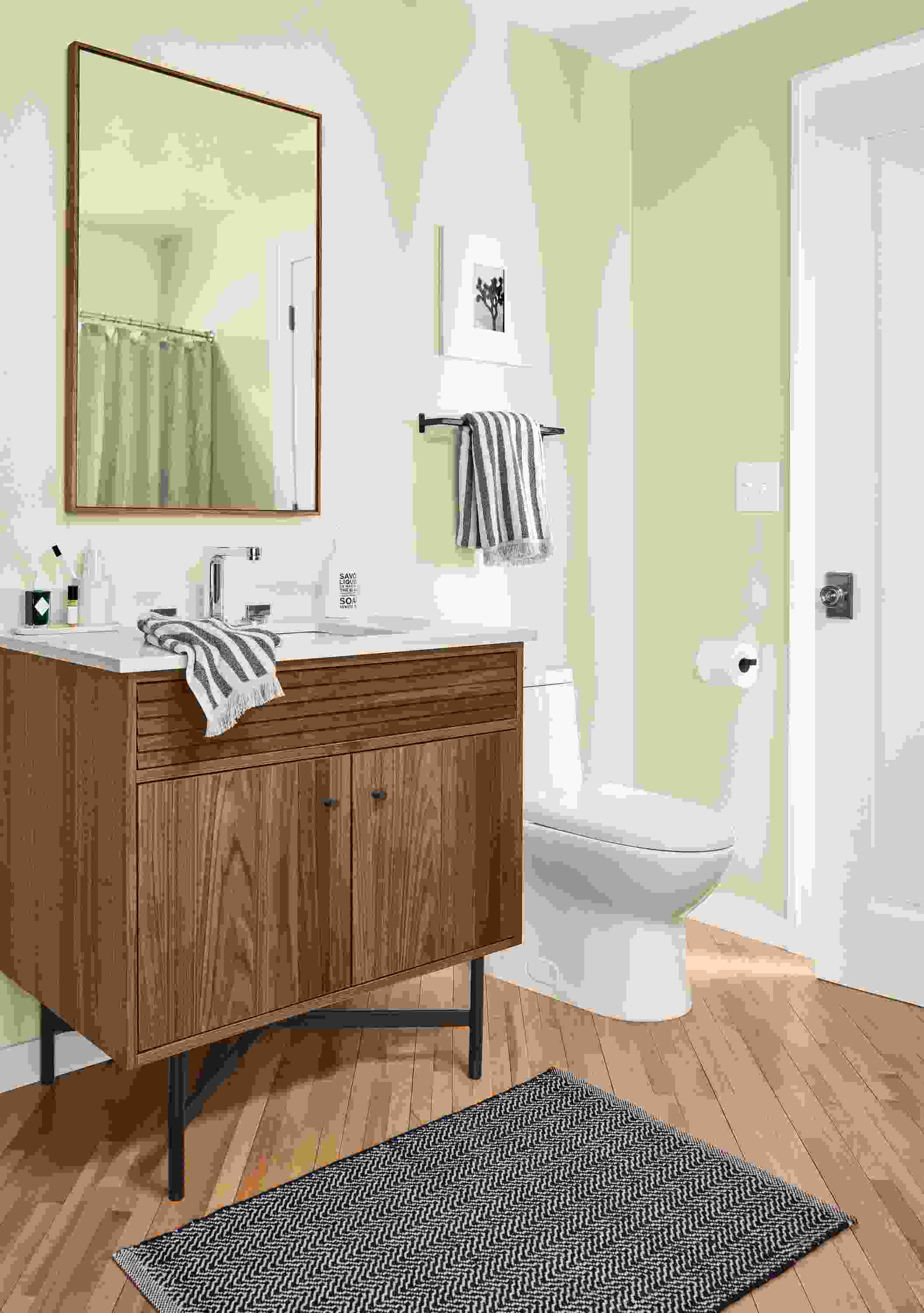 Bathroom with Adrian vanity in walnut with white quartz top, Hudson mirror in walnut and slip towel rack in graphite.