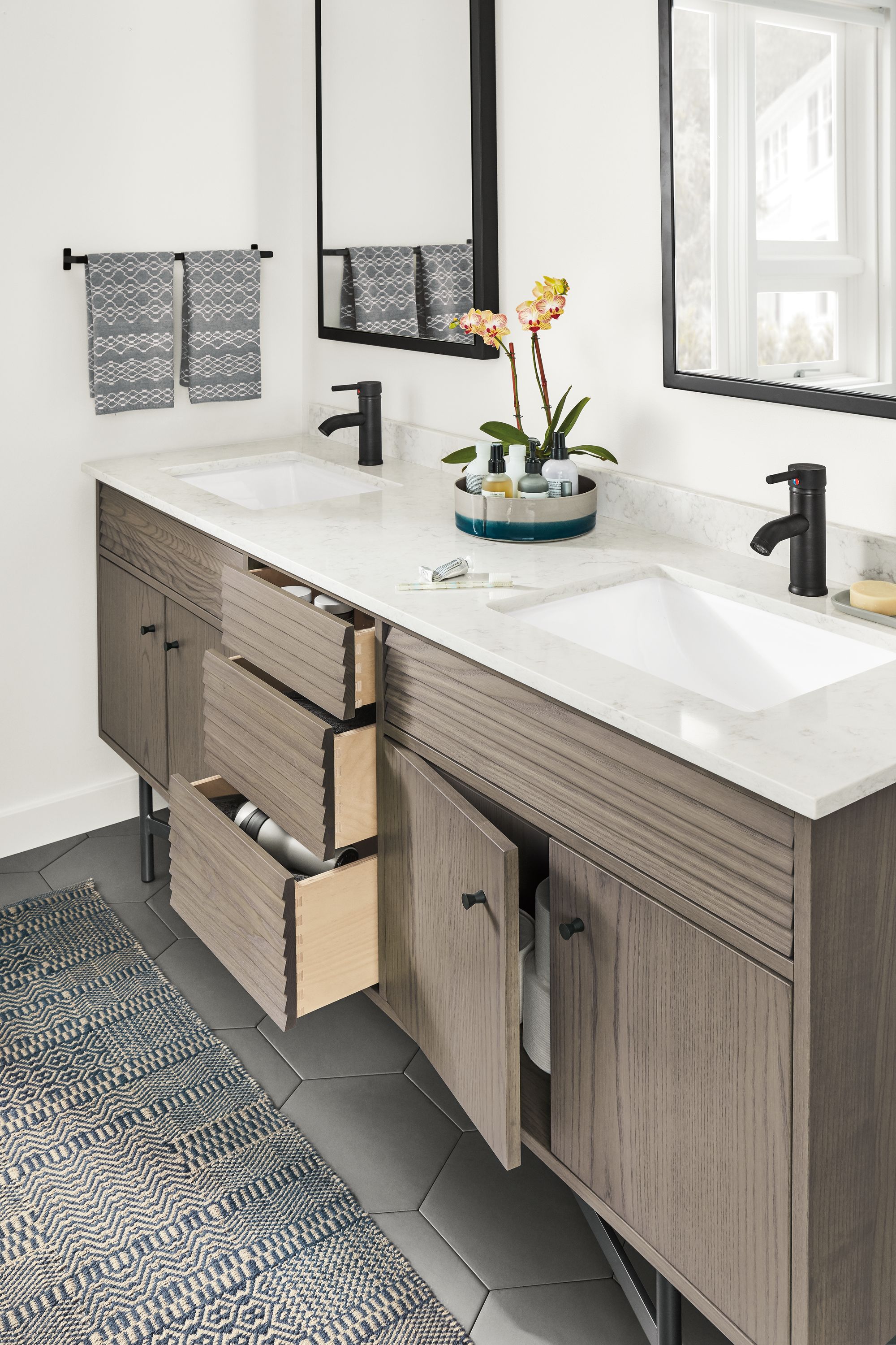 Bathroom with detail of Adrian bath vanity cabinet shown with  drawers partially open.
