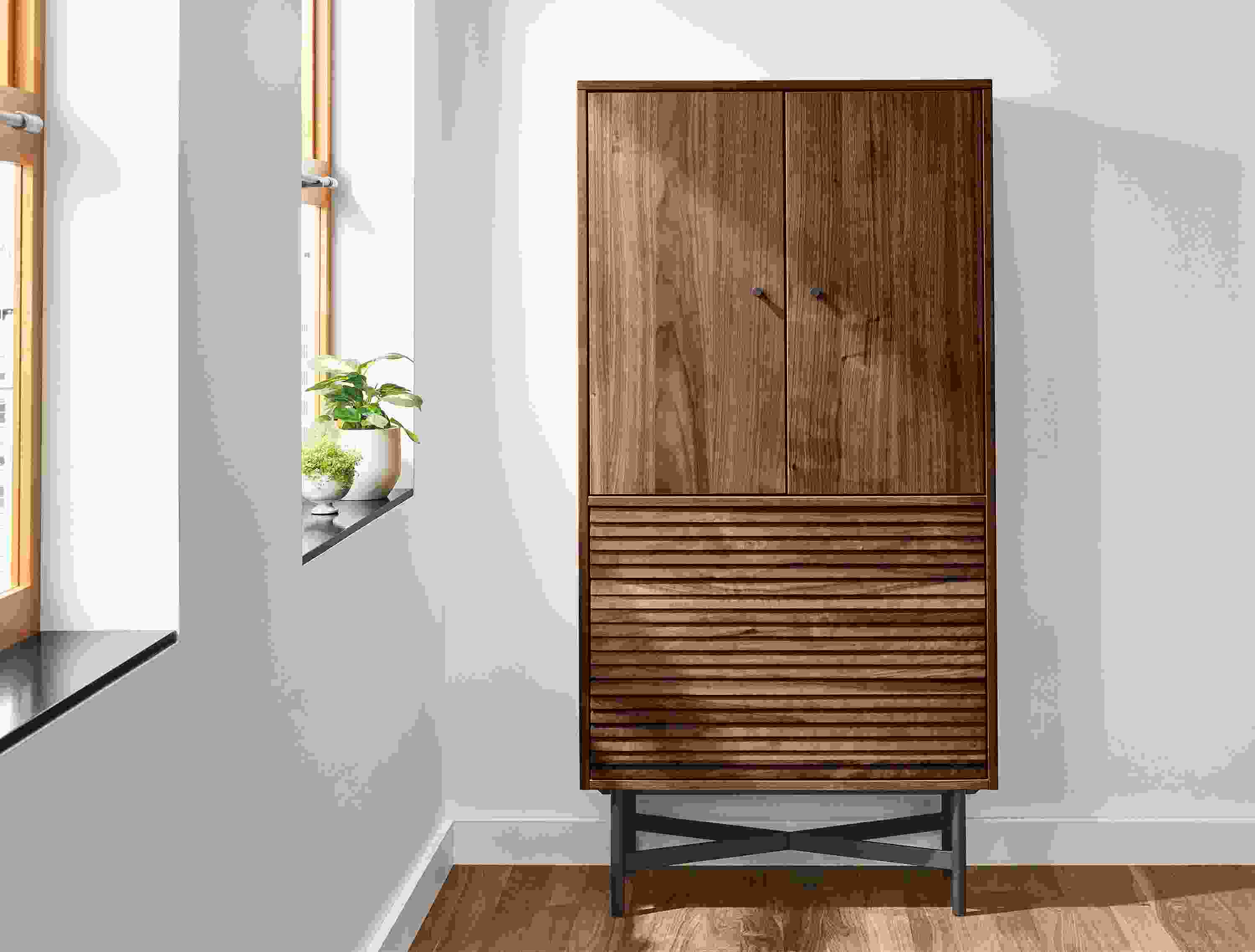 Detail of Adrian 30-wide storage cabinet in walnut.