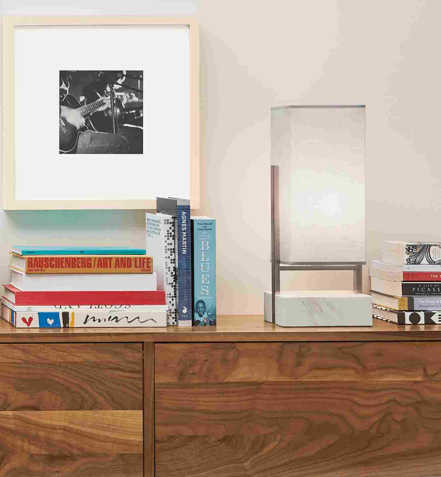 Detail of Adwell Table Lamp in marble on a Hover media cabinet in walnut.