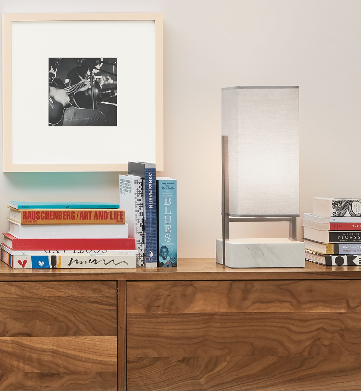 Detail of Adwell Table Lamp in marble on a Hover media cabinet in walnut.