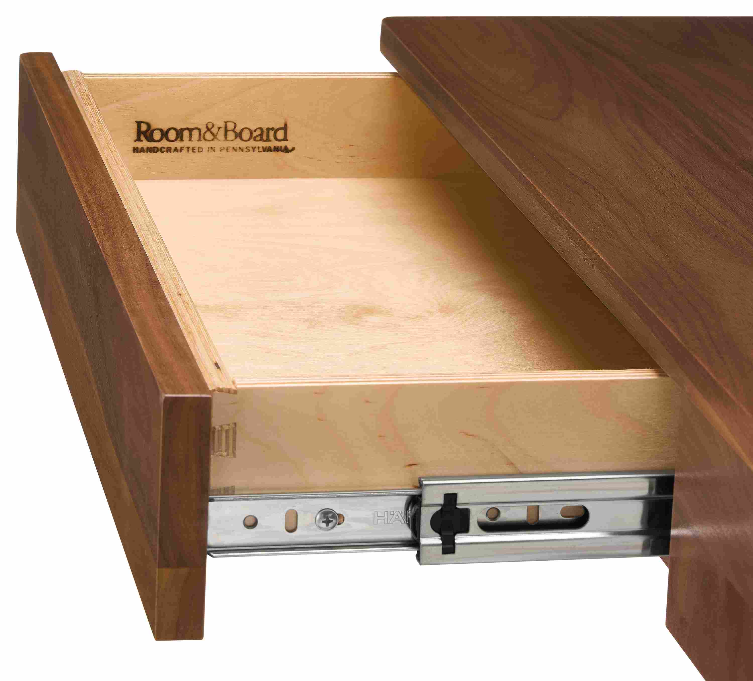 Detail of Aedric  desk in walnut showing open drawer and slide mechanism.