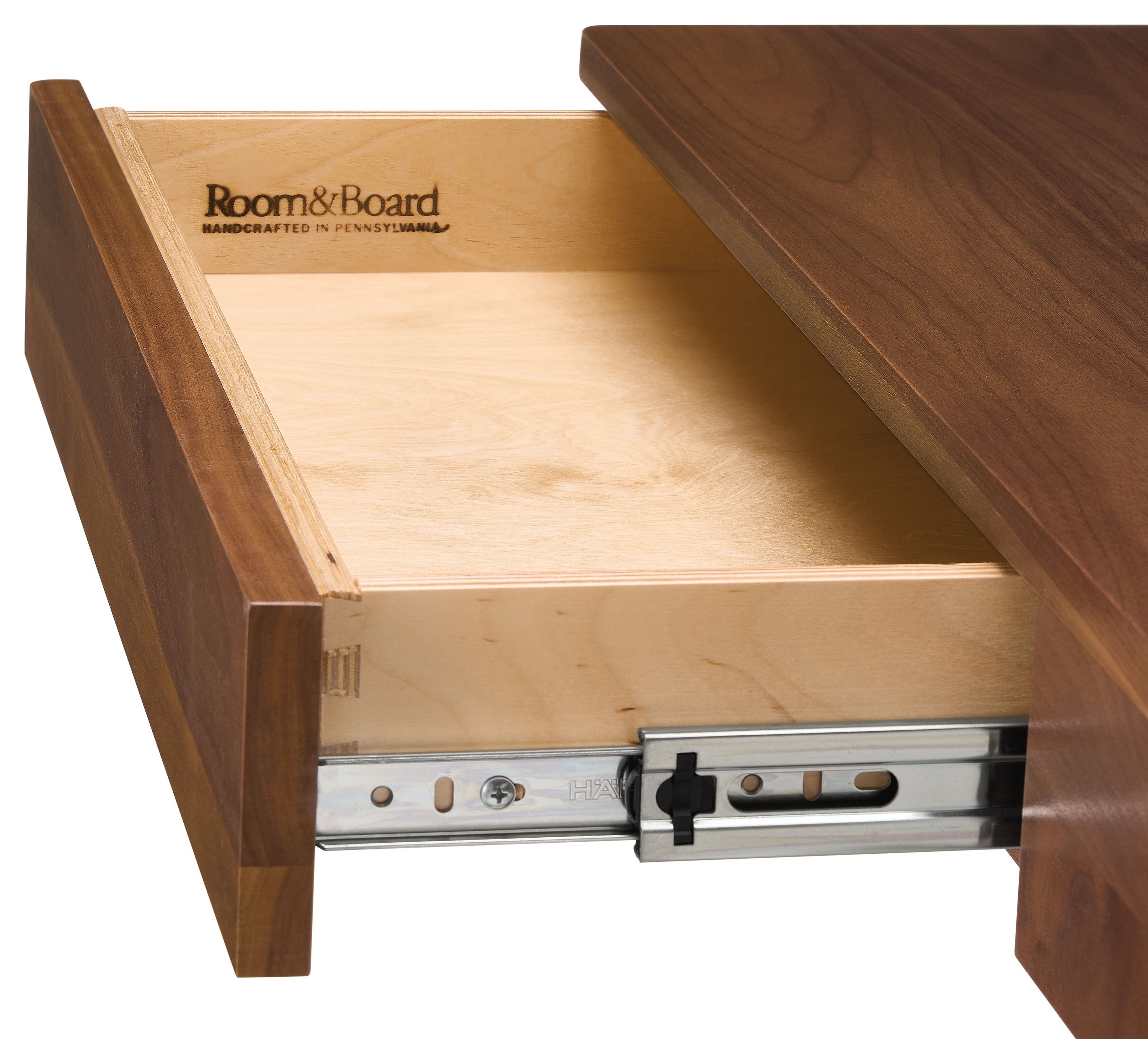 Detail of Aedric  desk in walnut showing open drawer and slide mechanism.