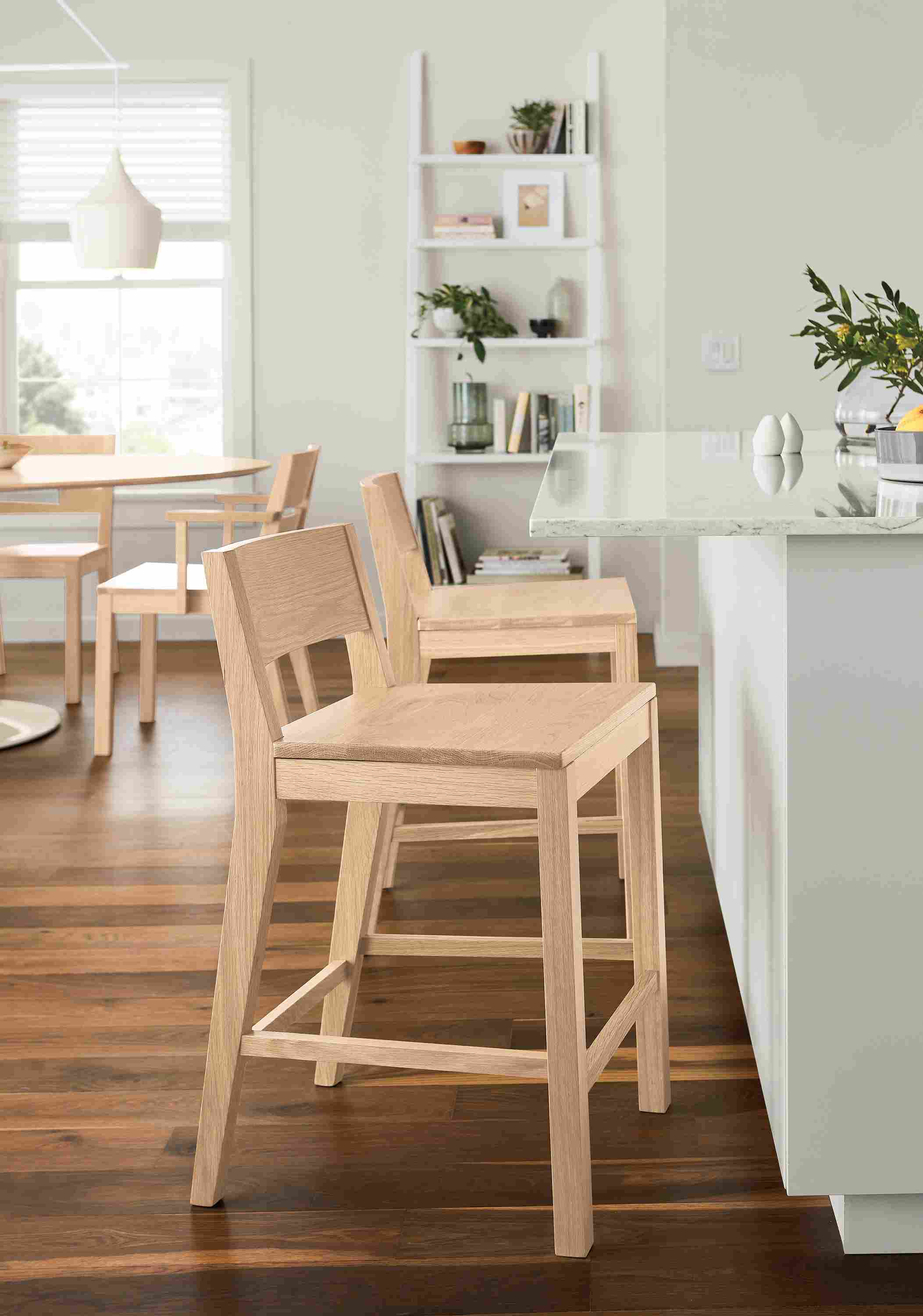 Kitchen counter with 2 afton counter stools with wood seat in salt on red oak and aria oval table in salt on red oak.