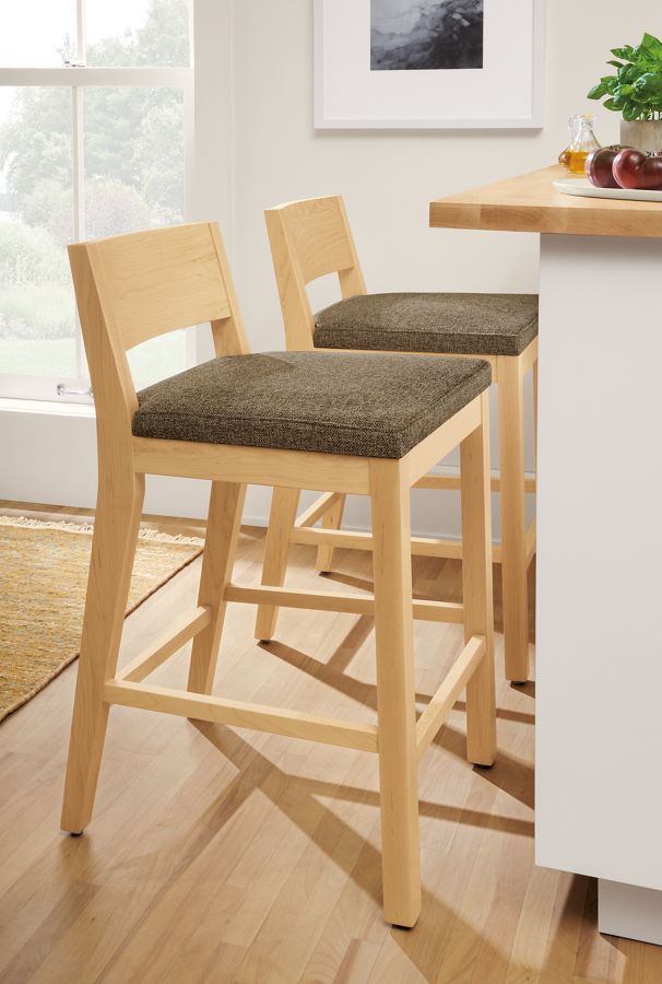 Detail of Afton counter stools in maple with Tatum fabric seat at kitchen counter.