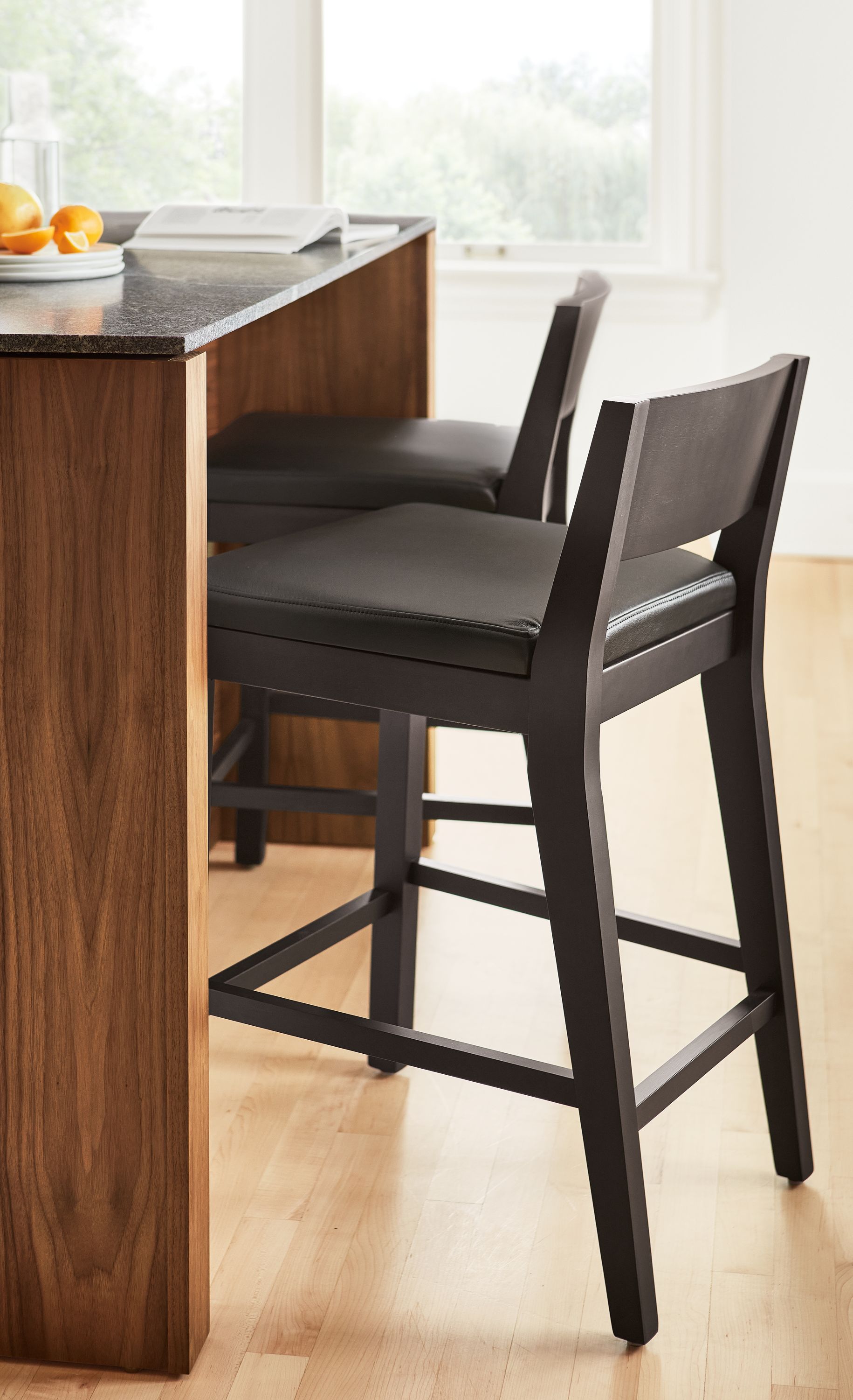 Kitchen with Afton counter stools in charcoal and black leather and Amherst Kitchen Island.