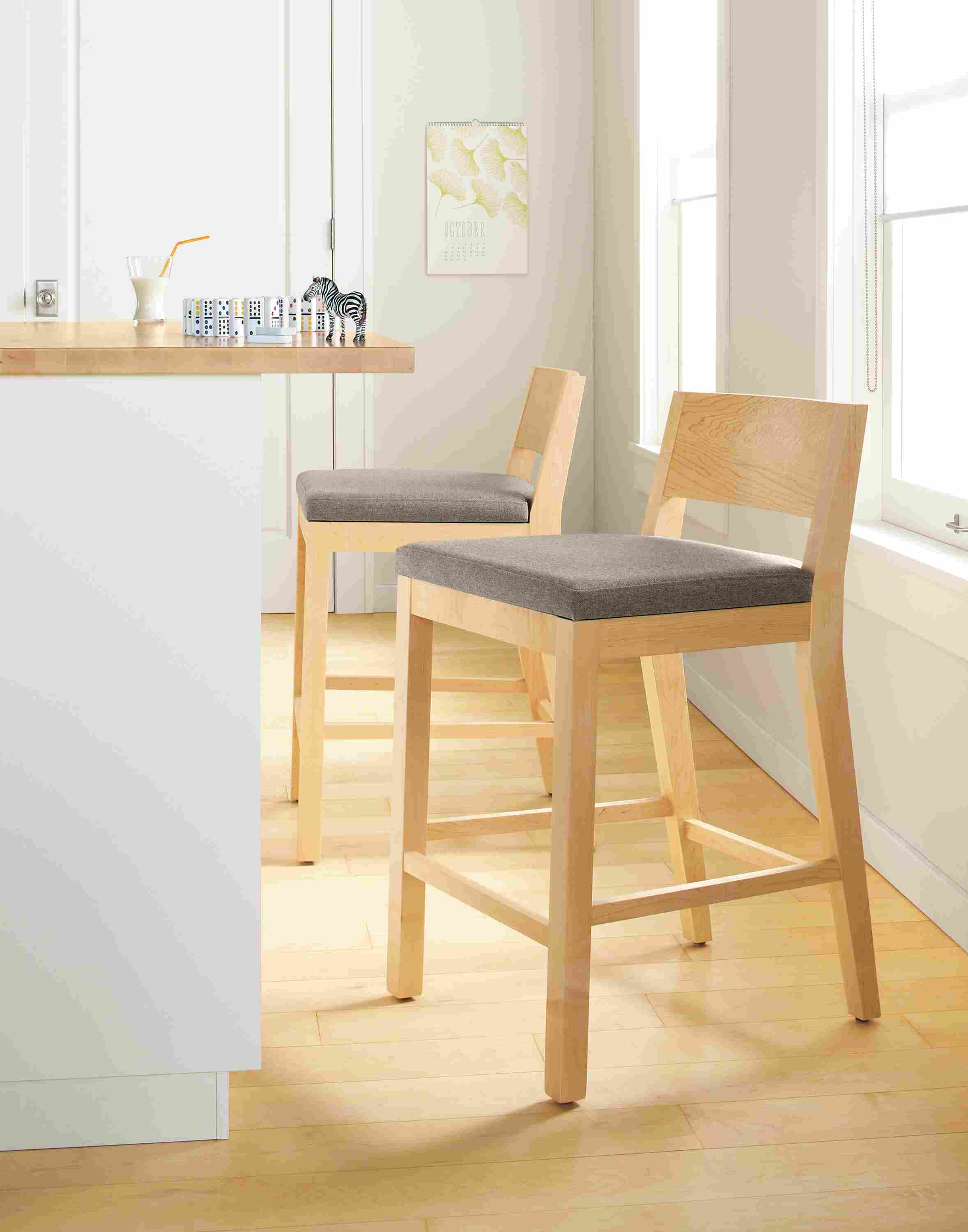 Kitchen counter with Afton counter stools in maple with Flint Ivory fabric.