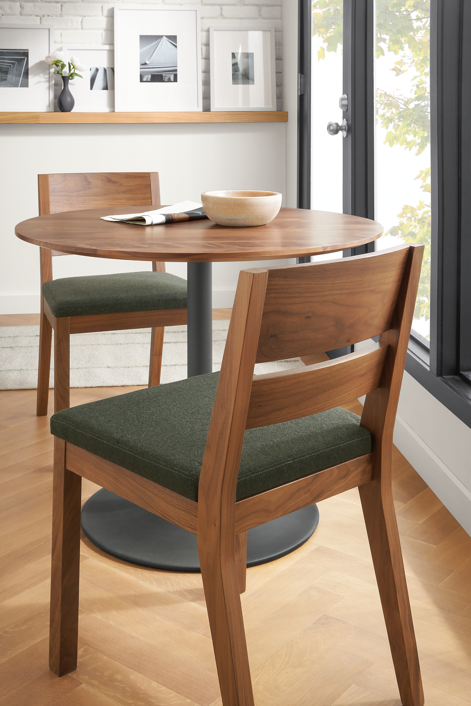 Detail of 2 Afton side chairs in walnut with Flint fabric seat at round kitchen table.