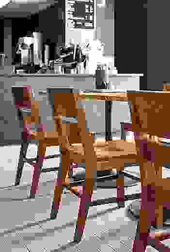 Detail of Afton side chair with wood seat, in cafe.