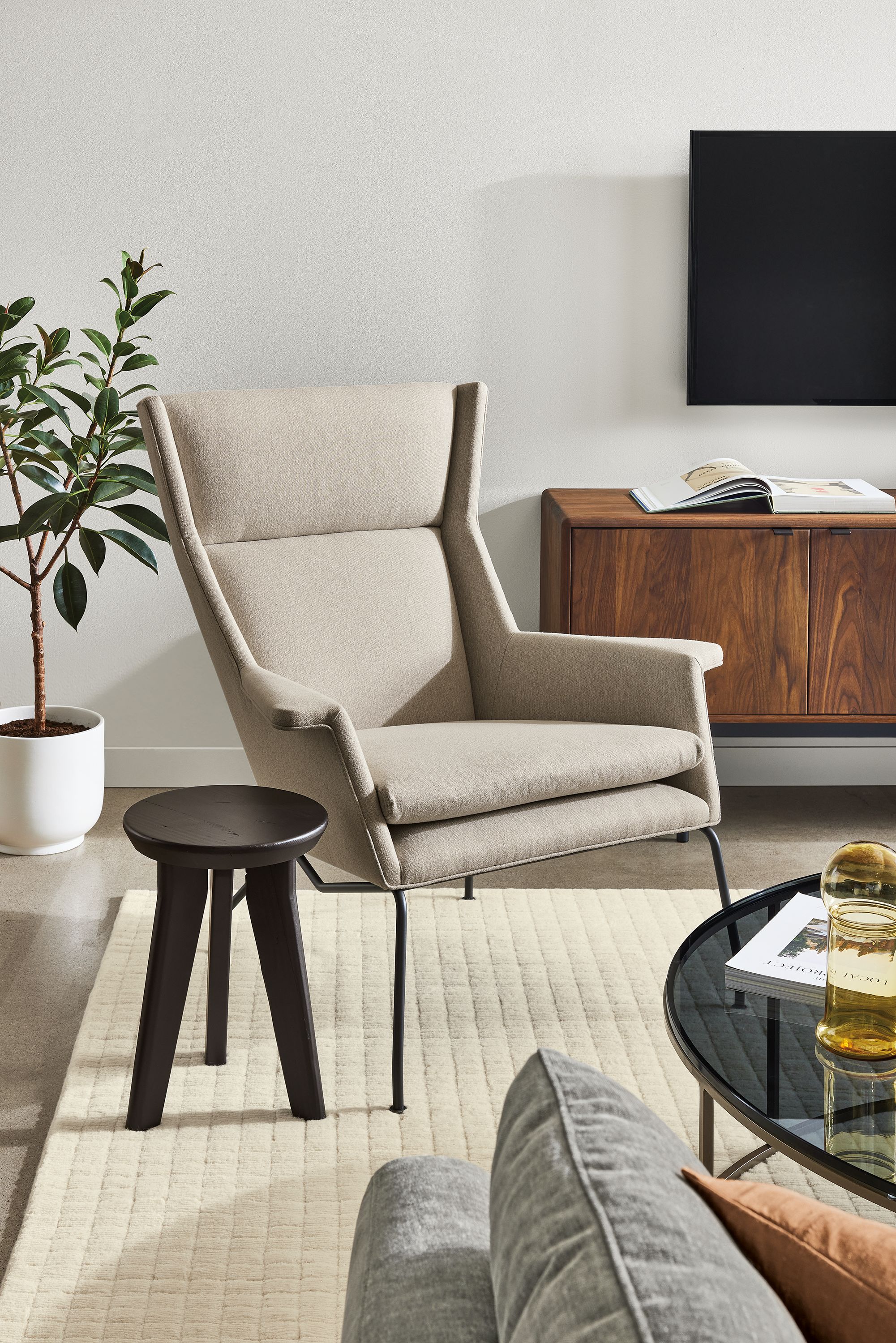 living room with aidan chair, hollins stool and hensley media cabinet.