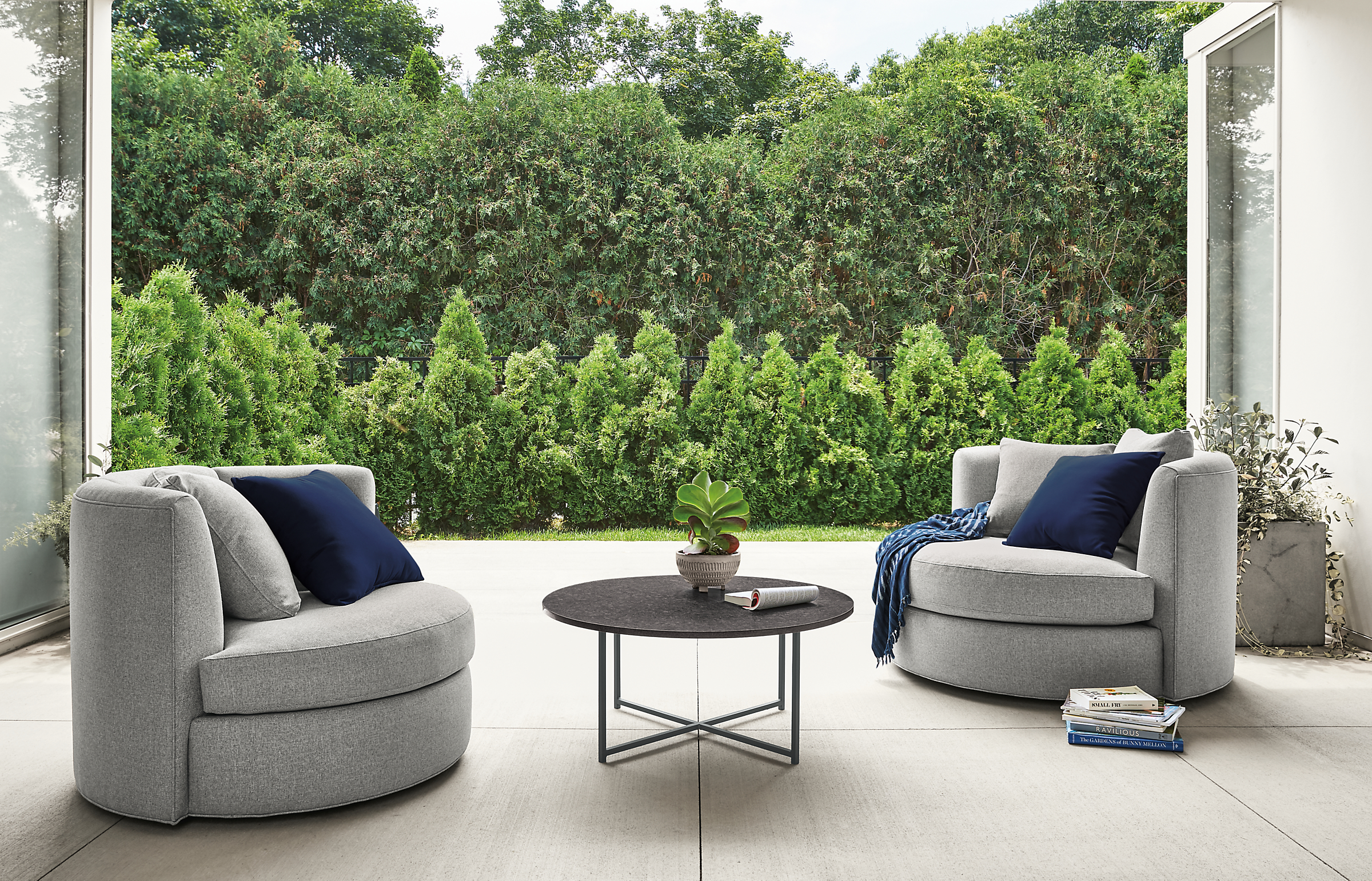 Detail of 2 Alcove swivel chairs in mist steel on patio.