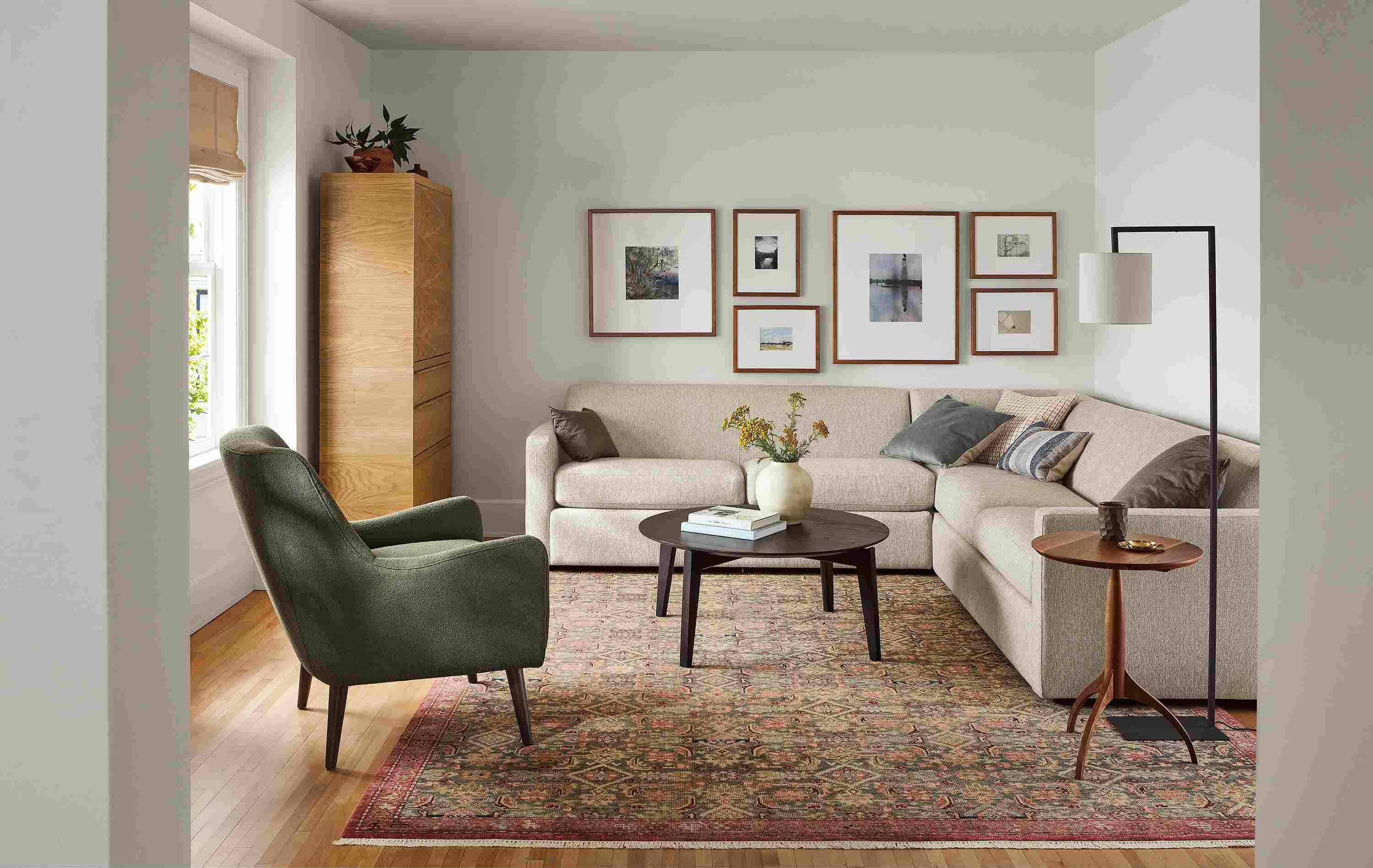 Living room with Alex sectional in Tepic Oatmeal, Orlin coffee table in charcoal and Quinn chair in Declan Olive.