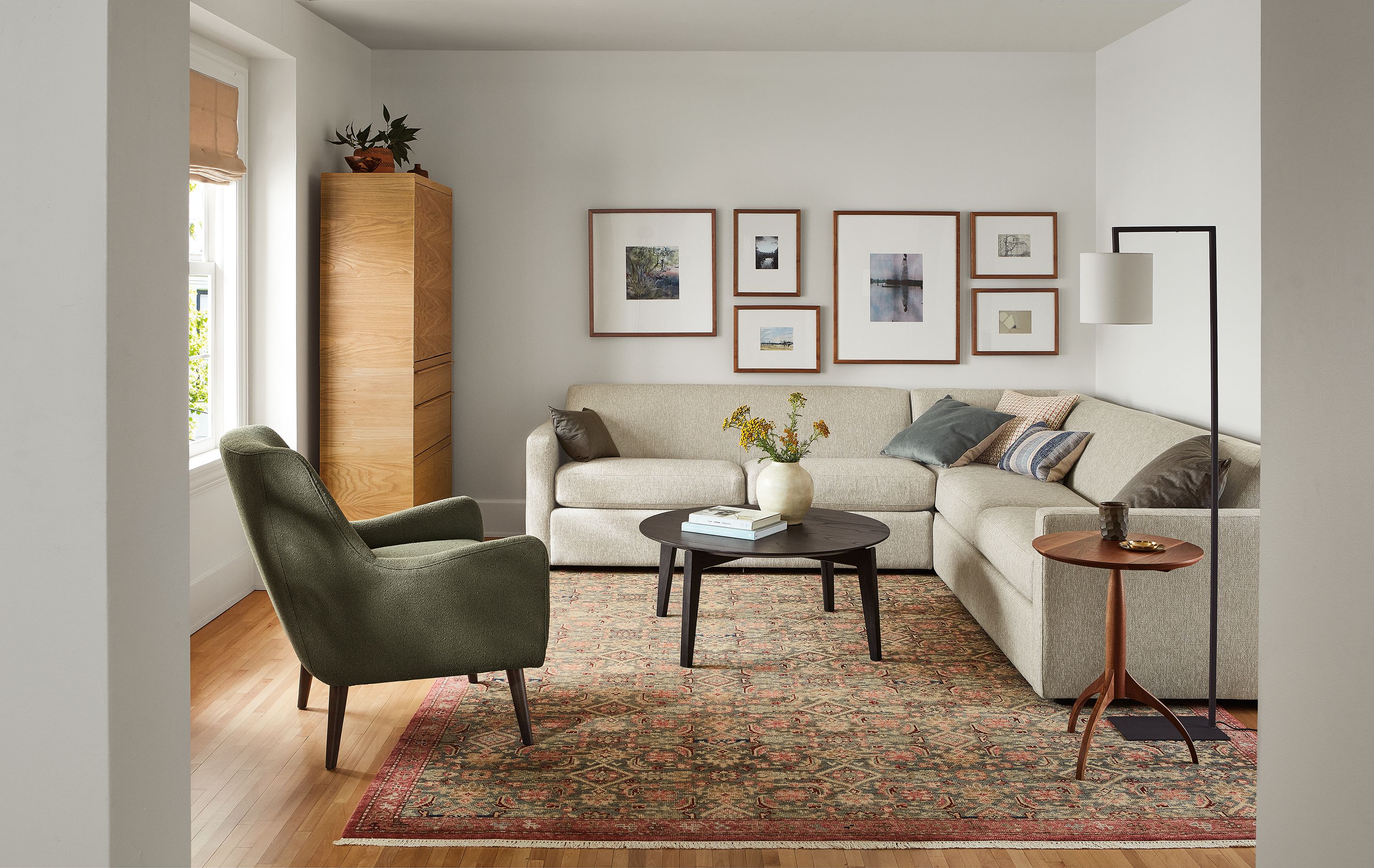 Living room with Alex sectional in Tepic Oatmeal, Orlin coffee table in charcoal and Quinn chair in Declan Olive.
