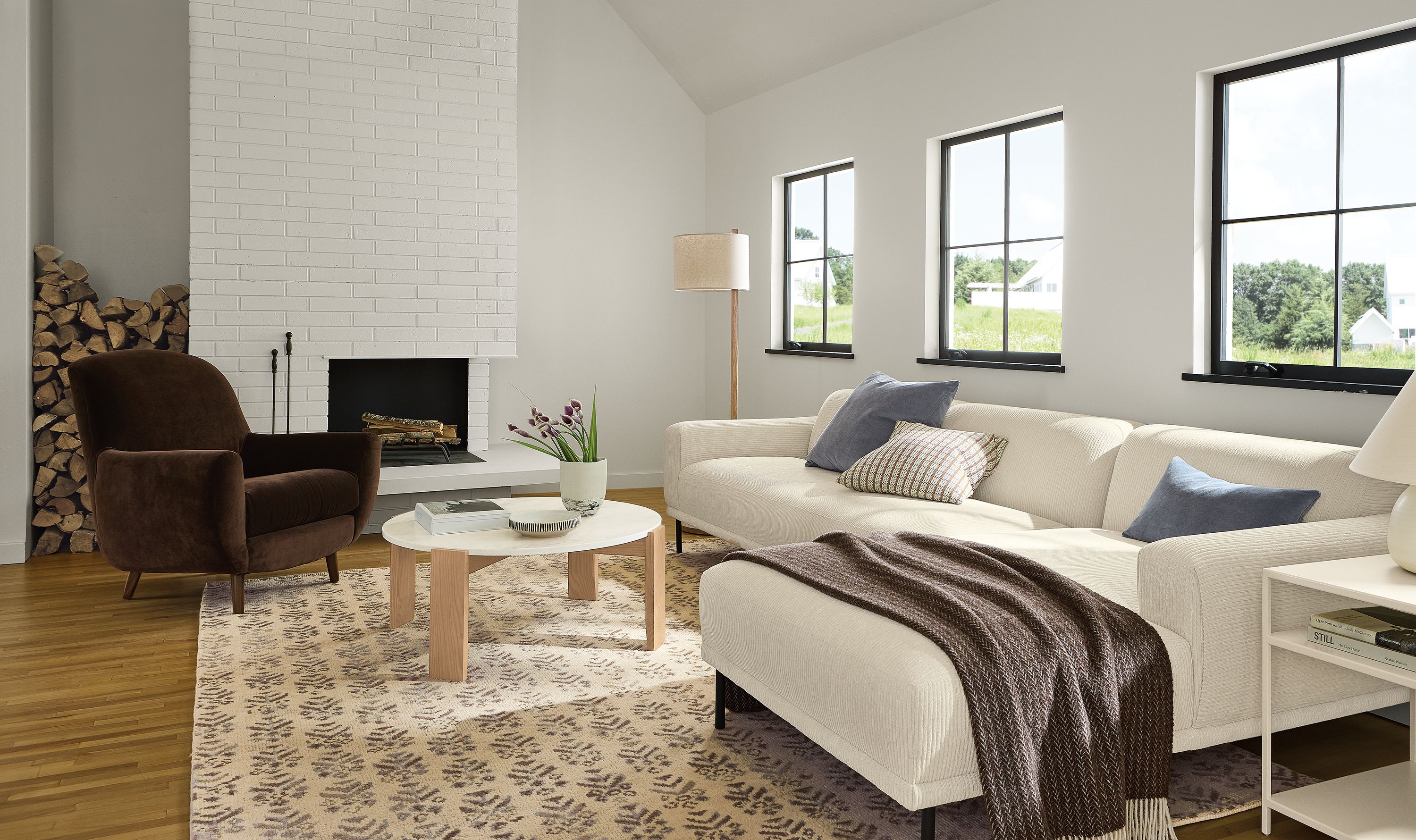 Living room with Ali 115-wide sofa with right arm chaise in brava ivory and Leroy chair in redding espresso.