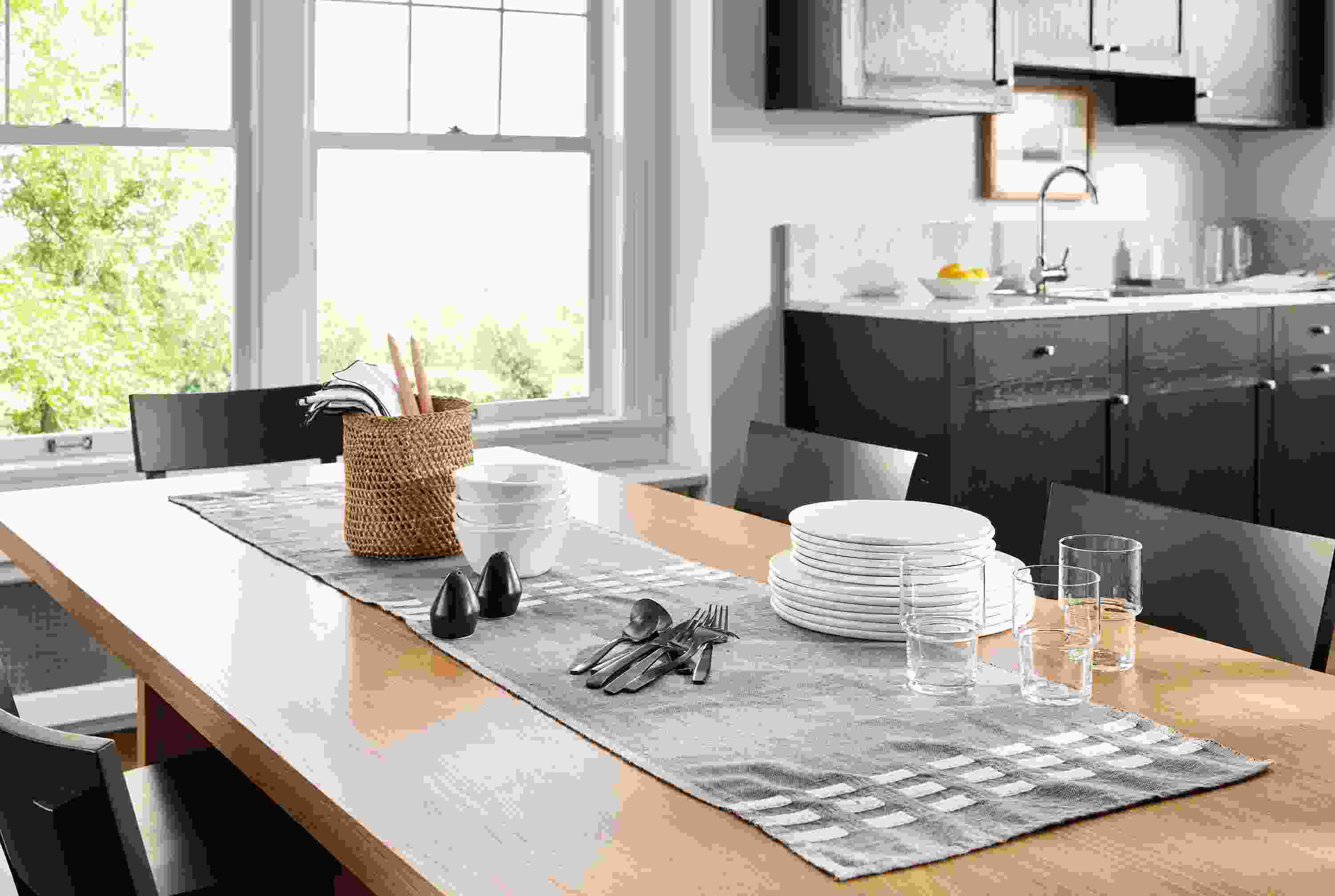 Kitchen dining area with an Allen table runner in charcoal on a Corbett 82-wide table in white oak.