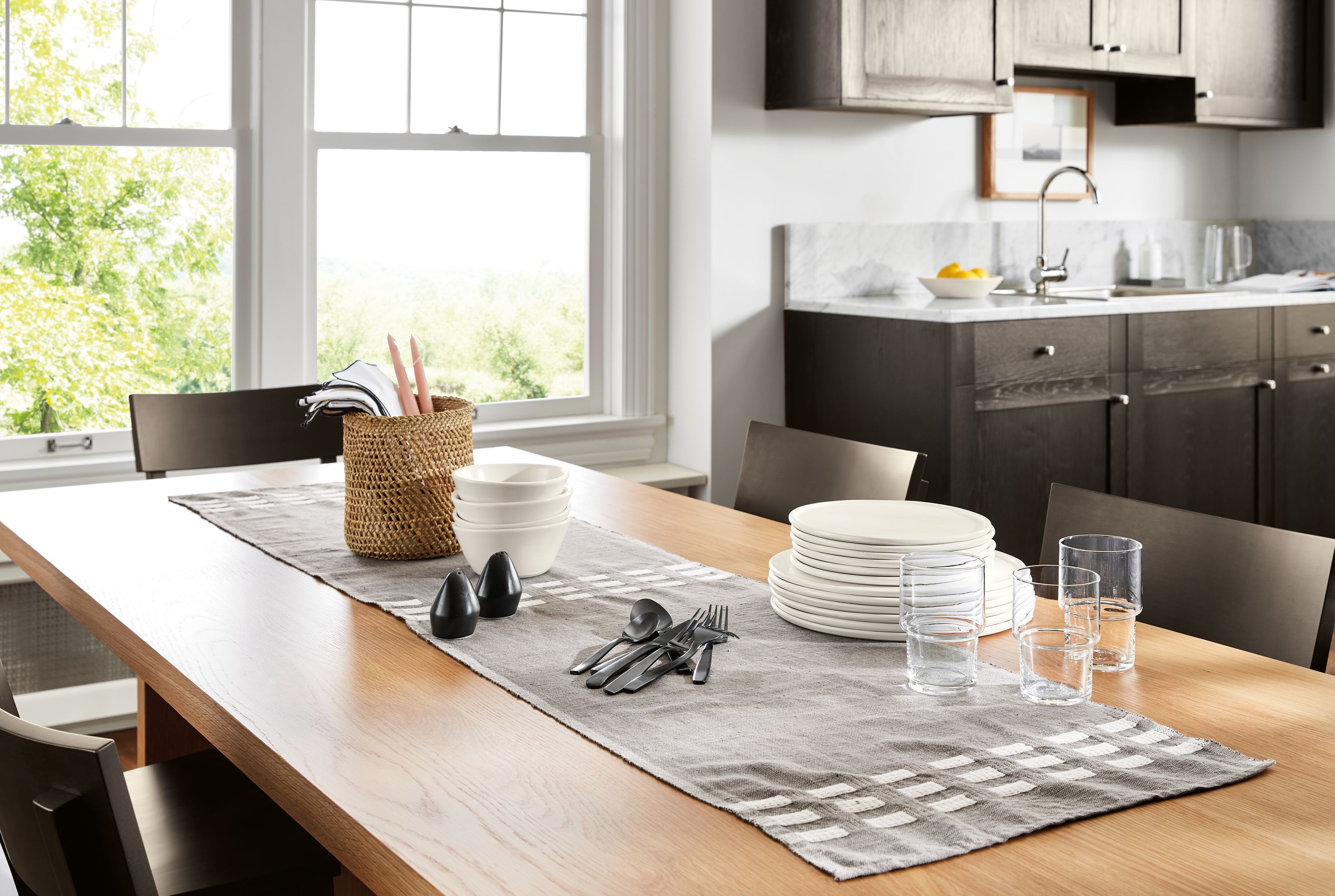 Kitchen dining area with an Allen table runner in charcoal on a Corbett 82-wide table in white oak.