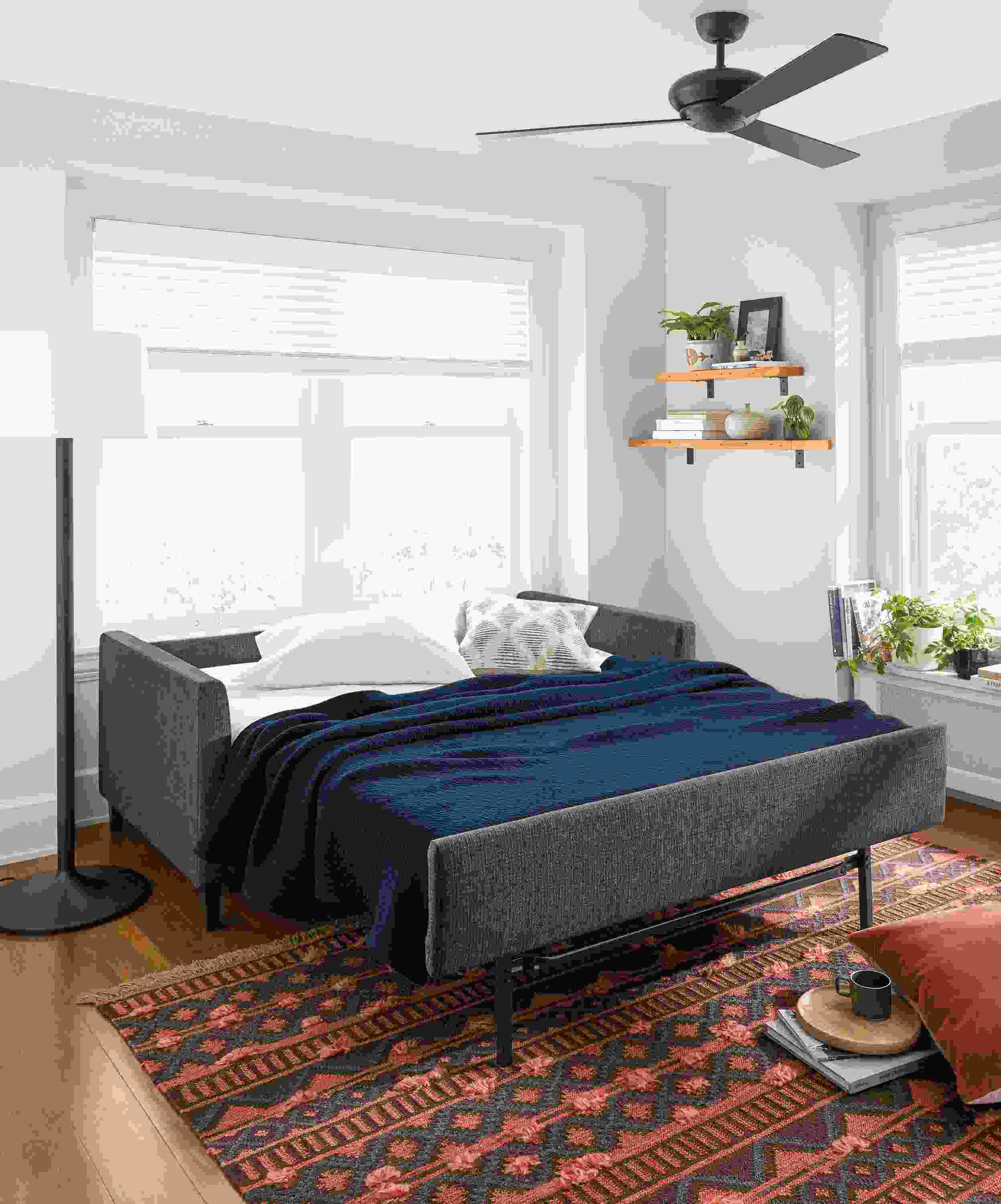 Allston sleeper sofa open with bedding.