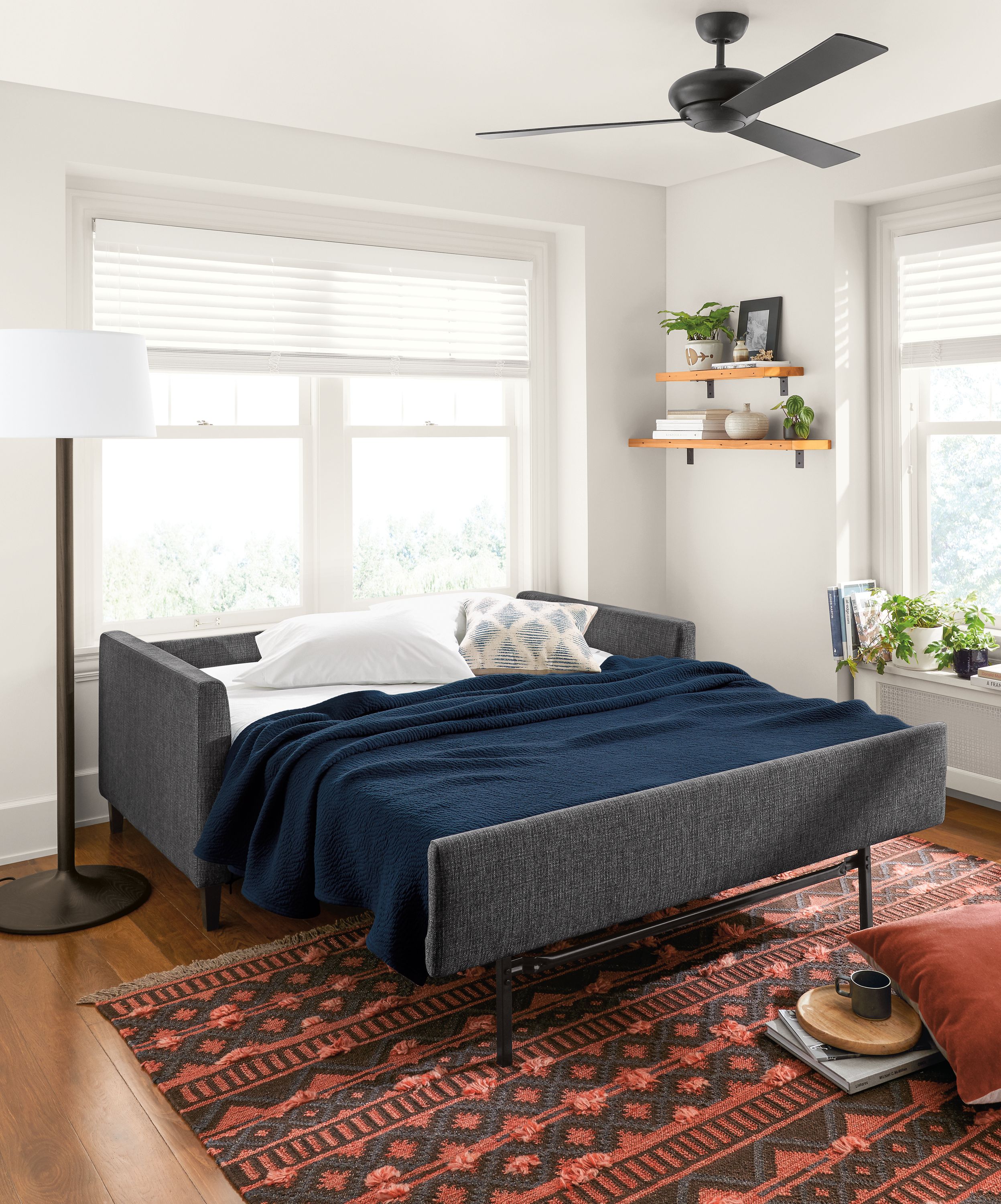 Allston sleeper sofa open with bedding.