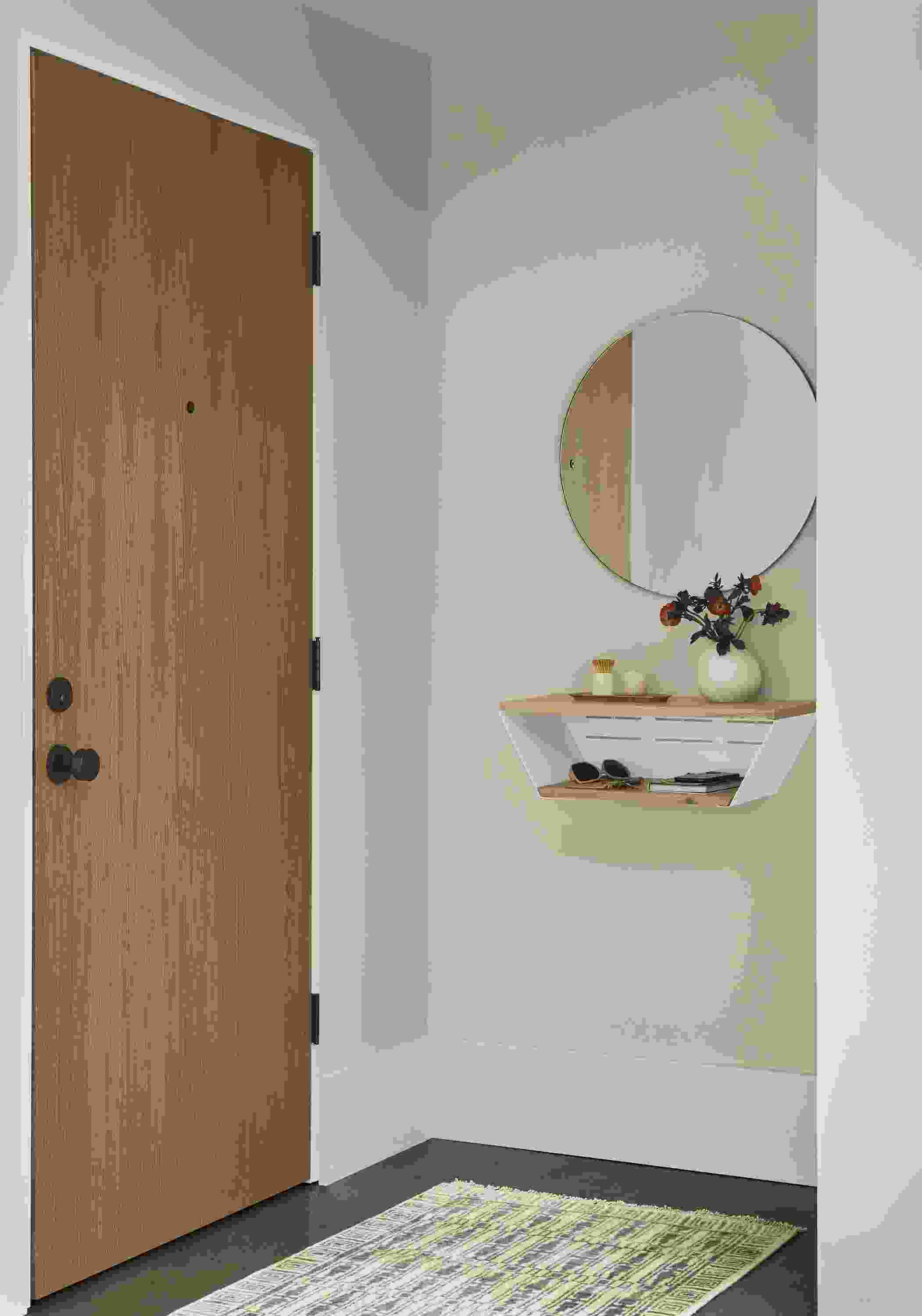 Entryway with Alta 24-wide wall shelf in reclaimed black oak and Tulum rug in taupe.