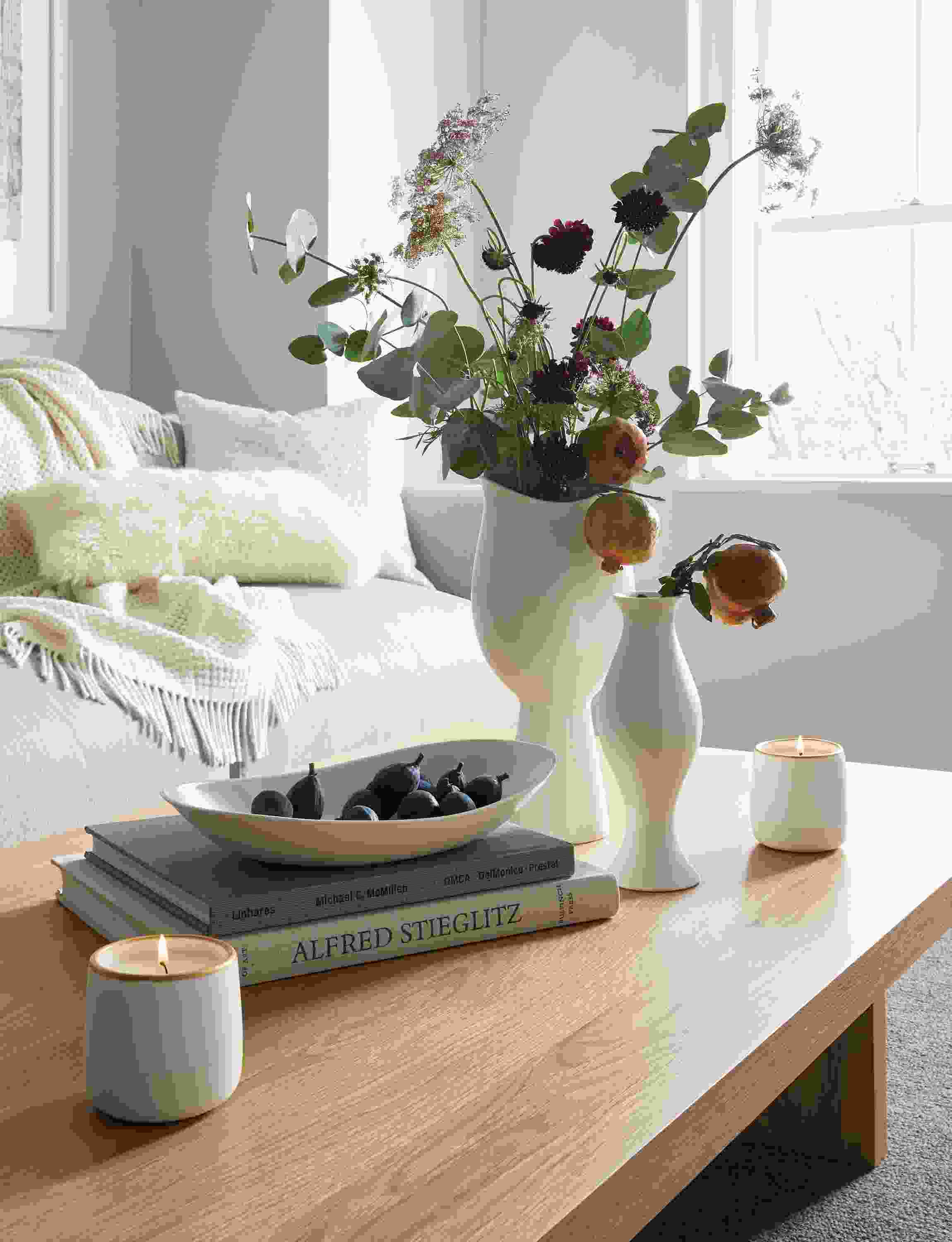Detail of Althea vases in ivory in living room on Corbett coffee table in white oak.