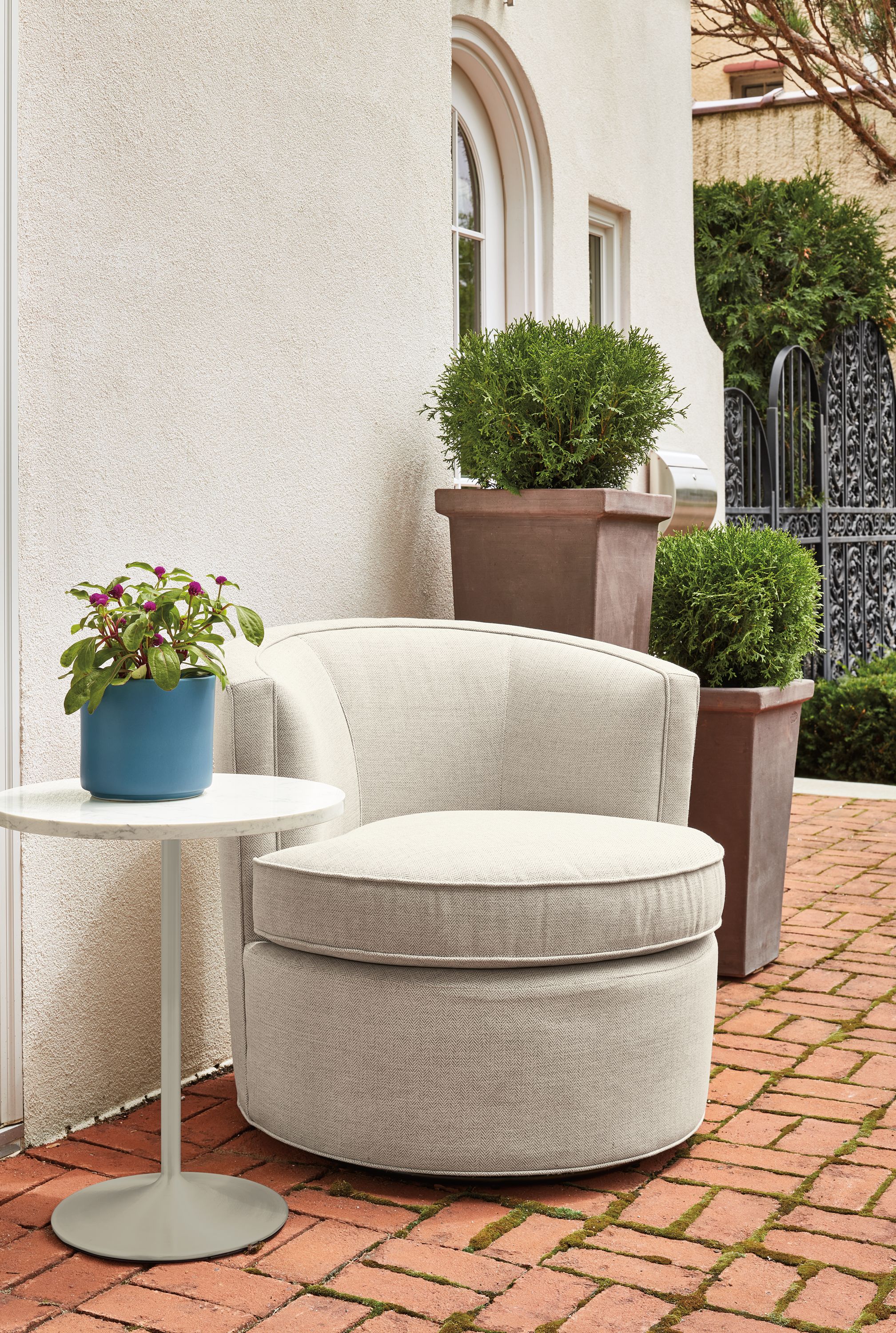 Ambrose Swivel Chair in Corso Grey with Aria 18-Round Side Table in taupe with Marble white quartz top.